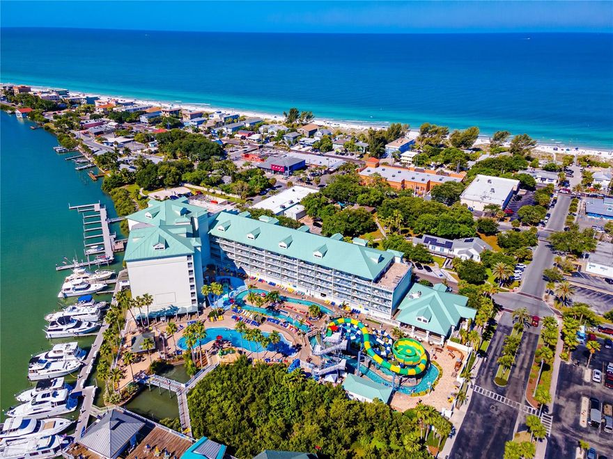 Turnkey 2BR/2BA condo-hotel at Harbourside at Marker 33, just steps to the beach and Splash Harbour Waterpark, the only waterpark on the barrier islands! Located on the Point of the building, this fully furnished 2nd-floor unit offers spectacular, unparalleled direct water views of the Intracoastal from a 23-ft wide balcony, as well as access to a 7th floor rooftop sundeck with stunning sunset views of the Gulf!
Designed for short-term rentals (3-night min, up to 120 days), this property offers excellent income potential and the flexibility for personal use. Split floor plan includes a spacious primary suite with king bed and walk-in shower, and a second suite with two queen beds and a full bath. Open kitchen, dining, and living area with ceramic plank floors, granite counters, shaker cabinets, and in-unit washer/dryer.
Sale includes all furnishings, décor, appliances, linens, dishware, and beach gear—truly move-in or rent-ready. Owners and guests enjoy free daily waterpark passes, rooftop terraces, garage parking, and access to on-site amenities including restaurants, poolside service, adult beverages, and a Tiki Hut. The Waterpark has a lazy river, waterslides, splash pad and pool – something for everyone! Enjoy live music in the evenings, movies and sports projected on a wall of the building, and a Poolside Tiki Bar and gift shop. Harbourside Day Docks are available for our guests traveling by boat. Boat and bicycle rentals are also available nearby. Located near restaurants, shops, and just a short drive to Clearwater Beach, John’s Pass, and two major airports (TPA & PIE).