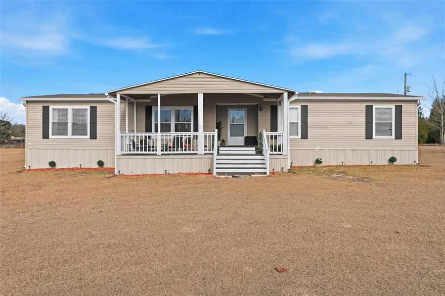 FULLY FURNISHED 2,512 sqft manufactured home! Nestled on 5 sprawling acres of gently rolling land dotted with majestic oak trees, this stunning home offers peace, privacy, and true Florida country living—just minutes from Ichetucknee Springs. Tucked away on a quiet road yet close to paved access, this property provides the perfect balance of seclusion and convenience. The location is ideal, minutes from an A-rated elementary school and an A-rated private charter school serving grades K-12, making this home as practical as it is peaceful. Enjoy breathtaking sunsets, abundant wildlife, and no HOA or restrictions, giving you the freedom to truly make this property your own. The open, scenic setting creates a serene backdrop for everyday living and entertaining. Inside, the home features upgraded appliances, solid-surface kitchen countertops, and stylish barn doors. The spacious primary suite boasts a large custom walk-in closet complete with shelving and a center island with drawers, along with an upgraded primary bathroom designed for comfort and relaxation. Additional highlights include a large laundry room with ample storage and a bonus storage room, two living areas, a dedicated dining space, and both front and back porches—perfect for enjoying the peaceful surroundings. This exceptional property is truly move-in ready and showcases the best of open-land living. A rare opportunity to own a beautiful, unrestricted property in a highly desirable location