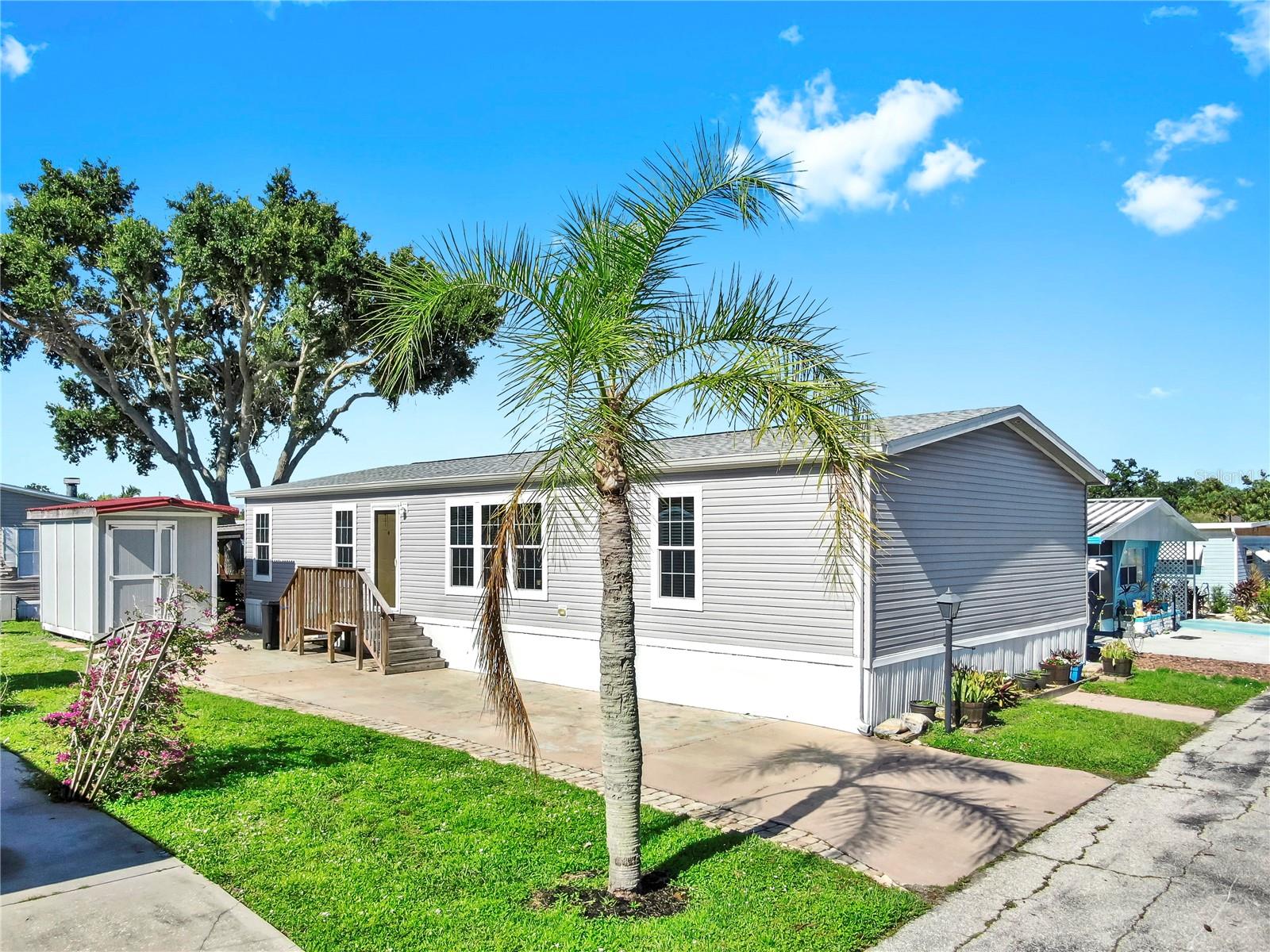 Welcome to this beautifully maintained and nearly new 3-bedroom, 2-bathroom home in a desirable 55+ co-op community. Built in 2019 and situated on Lot 64 with Share Certificate ownership, this spacious 1,494 sq ft residence offers premium upgrades and worry-free living in a Wind Zone III-rated home (hurricane-rated to 150 mph).
Enjoy a bright, open layout with interior drywall walls/ceilings, overhead ductwork, R30 roof insulation, and Low-E insulated windows with professionally installed 3M window tint. The kitchen features LED recessed lighting, mosaic tile backsplash, luxury vinyl flooring, and brand-new stainless appliances including a glass-top range, microwave, dishwasher, and double sink with gooseneck pull-down faucet. A reclining sofa set and dining table with seating for 6 are included!
The primary suite boasts a walk-in closet, plush new carpet, a soaker tub, 48” rainforest shower, and mosaic accents. Additional highlights include new shingle roof, 6-panel doors, 2” window blinds, upgraded smoke/CO2 detectors, and Fanimation LED ceiling fans.
Step outside to a covered solid wood patio with metal roofing, complete with patio furniture, and an insulated 8x12 shed wired for electricity—perfect for storage or hobbies.
This move-in-ready gem offers comfort, style, and peace of mind—all in a friendly and well-kept 55+ community. Schedule your showing today!