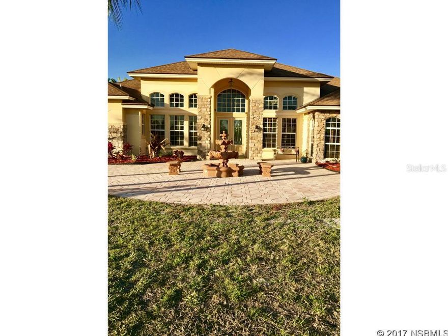 Come by and see this incredible Tropical Oasis! This beautiful 4 bedroom 3 bath Pool home sits on 7 acres and is fully fenced wih a gated entry.   The gourmet Chef's   Kitchen features maple wood ginger glazed cabinets, an island with soft close drawers and many other extras, also granite counter tops and a large walk in pantry.  The Kitchen/Great room combo with a breakfast nook also has a 6 person granite breakfast bar.  The large master bedroom has his and hers walk in California closets and the Master bath has a wall to wall granite shower with a body spray, jetted Jacuzzi tub, tons of cabinet space and heated tile flooring in Master and Guest/Pool bathrooms.  There is even an office that can be converted into a 4th bedroom.  There is also a multi purpose building 30x45 that can house an RV, boat or be converted to a barn, workshop or in-law suite! The front courtyard is perfect to watch the Florida sunset and the back patio is great for any sized family to enjoy the Rock Waterfall Pool!  The property is zoned A2 for an agricultural business so there are many possibilities!! You must see this Paradise of a home before it goes!!