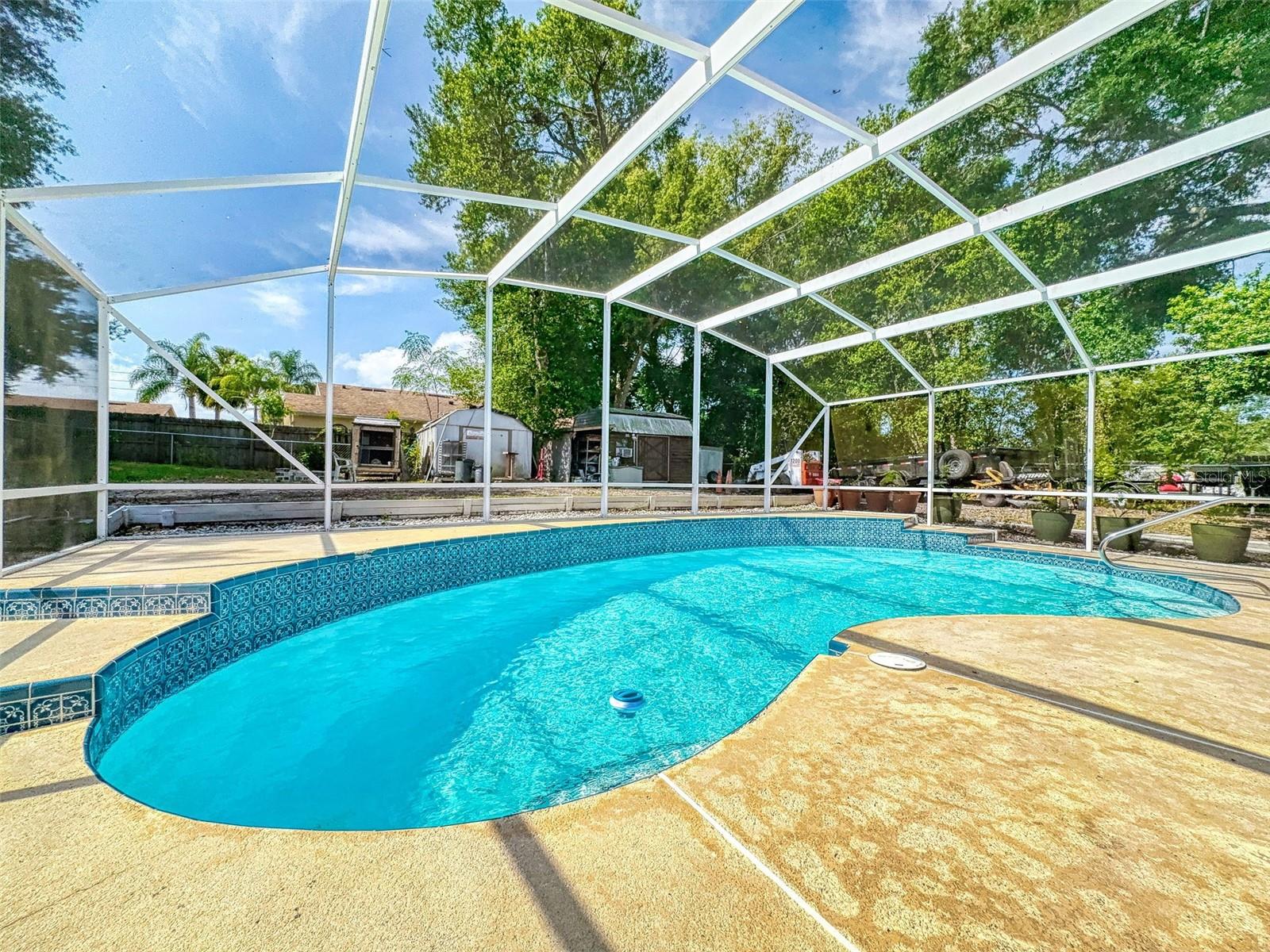What an opportunity to buy this awesome 3/2 screened POOL home in a perfect location!! This sturdy block home features a split bedroom plan, open great room living space, completely remodeled kitchen with QUARTZ countertops and CUSTOM wood cabinets with a counter island bar for entertaining and casual meals! Seated on a large lot, the backyard is fenced, with a large, screened lanai and pool area overlooks a sparkling large POOL for those summer parties with a brand-new pool pump, a shed with AC for storage or small workshop. Alot of upgrades and remodels! You can have your own home oasis to relax and enjoy! Close to shopping school and main arteries and yet very private! Please see attached website and 3D tour for further details!
