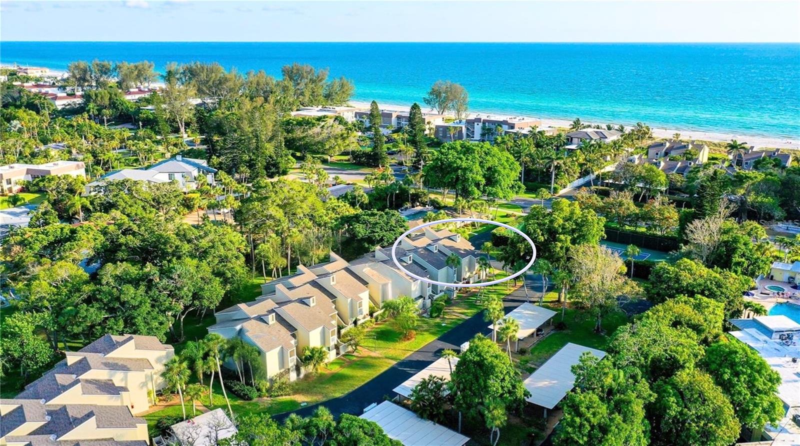 Welcome to your tropical retreat on Longboat Key! This newly renovated 2BR/2BA ground floor, end-unit coastal home combines relaxed elegance with modern comfort. Stylish updates include neutral tile flooring throughout (no carpet!), crown molding, upgraded baseboards, fresh paint, in-unit laundry with full-sized machines, a private exterior storage room, a peaceful garden-view lanai, and impact-rated PGT windows and sliders—offering both beauty and peace of mind. The kitchen shines with granite countertops, solid wood cabinetry, new stainless appliances, and a breakfast bar that opens to the light-filled living and dining areas—perfect for entertaining or everyday living. The spacious primary suite offers a walk-in closet, updated ensuite bath, and a flexible bonus space ideal for a home office or third sleeping area. A split-bedroom layout ensures privacy, with the guest suite tucked behind a frosted glass door, featuring its own bath and linen closet. Ideally situated on the bayside of this coveted Gulf-to-Bay community, the home is steps from the clubhouse, fitness center, heated pool, kayak launch, fishing pier and tennis/pickleball courts—plus just moments from the deeded Gulf beach access. Spend your days kayaking Sarasota Bay and your evenings enjoying sunsets from the private beach—complete with complimentary chairs. Banyan Bay is an intimate, friendly community of just 44 homes, offering covered parking, and a rare to find pet-friendly policy with no size or breed restrictions. The community has passed its milestone inspection and is certified for another 10 years, providing added peace of mind. Rental-friendly (4 leases/year, 1-month minimum), this property is ideal as a full-time residence, vacation getaway, or income-producing investment. Located minutes from shops, dining, parks, St. Armands Circle, and downtown Sarasota. This is truly the best of Gulf-to-Bay living!