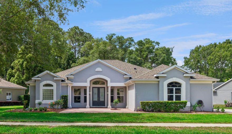 Beautifully updated and priced to sell! Move-in ready Timacuan Golf & Country Club home, listed UNDER APPRAISED VALUE $720,000! This one-story home has three spacious bedrooms with three full bathrooms, a private office, and a half bath. Low-maintenance and private - no backyard to mow, no rear neighbors, and an oversized screened patio that overlooks the natural beauty of the Crystal Lake Conservation Area. This is an IDEAL Lake Mary location, minutes to Publix, Orlando Health, AdventHealth, Colonial Town Park, Downtown Lake Mary, Interstate 4, and the 417 Expressway. This meticulously maintained one-story home offers nearly 2,600 square feet, a split floor plan, an open kitchen layout, a wood-burning fireplace, roof replacement in 2018, HVAC replacement in 2017, and updated kitchen and bathrooms. The kitchen is the heart of this home, featuring clean, white, granite countertops, modern gray wood cabinets, a large pantry, and brand-new stainless steel appliances. Built-in surround sound speakers enhance the home’s ambiance. The living room has a wood-burning fireplace for cozy evenings in. The formal dining room provides a lovely space for holiday meals and special events. Seamless white marble floors, fresh white paint, and an open layout connect the kitchen, family room, lanai, and patio. This is a nature-lover’s dream. Enjoy outdoor living on the expansive 60-foot, screen-enclosed patio that extends to the rear lot line. Trees provide natural shade and lush conservation views.  No backyard to mow! The oversized 1/3-acre lot has mature landscaping, fruit trees, and a front paver patio. The two-car garage has a 220-volt outlet for EV charging. The oversized driveway can easily accommodate four additional cars. Schedule your private showing today!