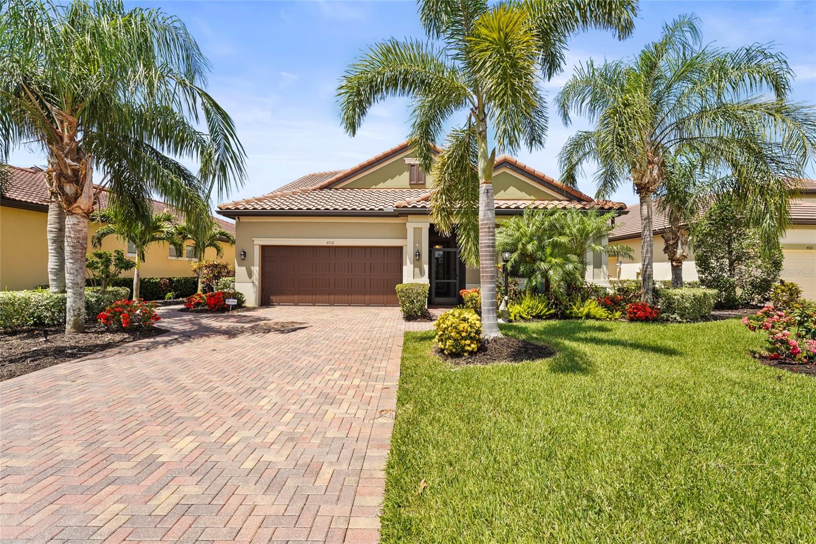 Your dream home awaits in the highly sought-after, amenity-rich Rosedale Golf & Country Club! This beautifully upgraded, former model home offers 4 bedrooms, 3.5 bathrooms, a sprawling upstairs bonus/media room, and over 3,000 sq ft of living space. From the moment you step through the screened portico you'll be delighted by the elegant finishes, thoughtful floor plan, and custom details throughout. A true showstopper designed for both everyday luxury and exceptional entertainment. The chef's kitchen features granite countertops, 42-inch wood cabinetry, stainless steel appliances- including a GE gas cooktop, built-in double ovens, a newer LG refrigerator, a spacious walk-in pantry, and a built-in wine bar. The home is adorned with crown molding throughout, upgraded light fixtures, wall paper, and wood trim accent details. The owner's suite is a private retreat with shiplap accents, a tray ceiling, and a desirable custom closet. The en-suite bathroom offers equal comfort with dual vanities, granite countertops, a soaking tub, and frameless glass shower. Two additional bedrooms are located on the first floor, one of which has a private attached bath. Upstairs you will find a large bedroom with double closets, a bathroom, and a bonus/media room equipped with a wet bar and wine refrigerator making it the perfect place to entertain guests. Your backyard is a private oasis with a sparkling pool and spa designed to include a built-in sun deck and swim-up bar stools, all surrounded by lush tropical landscaping, preserve views, a paved lanai, privacy wall, and fenced in yard. Additional upgrades include a 2024 pool heater, two 2022 HVAC 21-SEER units, built-in surround system, large laundry room with sink and storage, and epoxy garage floor fit for 2 cars + a golf cart with side entry into the garage. The HOA membership provides lawn care, cable, internet, and 24-hour security in this gated community with no CDD fees. Residents enjoy a social membership to the Rosedale Golf & Country club, featuring a Junior Olympic heated pool, fitness center, lighted Har-Tru tennis courts, a full-service restaurant and bar, a game room, and a vibrant social calendar. There is an additional mandatory social membership fee of $3,000 to be paid annually. For golf enthusiasts, separate memberships are available with no wait for membership for the 18-hole championship course. The community is pet-friendly with two dog parks. Conveniently located just minutes to the shopping and dining at UTC Mall, Lakewood Ranch Main Street, and the area's top-rated hospitals, schools, and world-renowned beaches. Living in Rosedale, every day feels like a vacation!