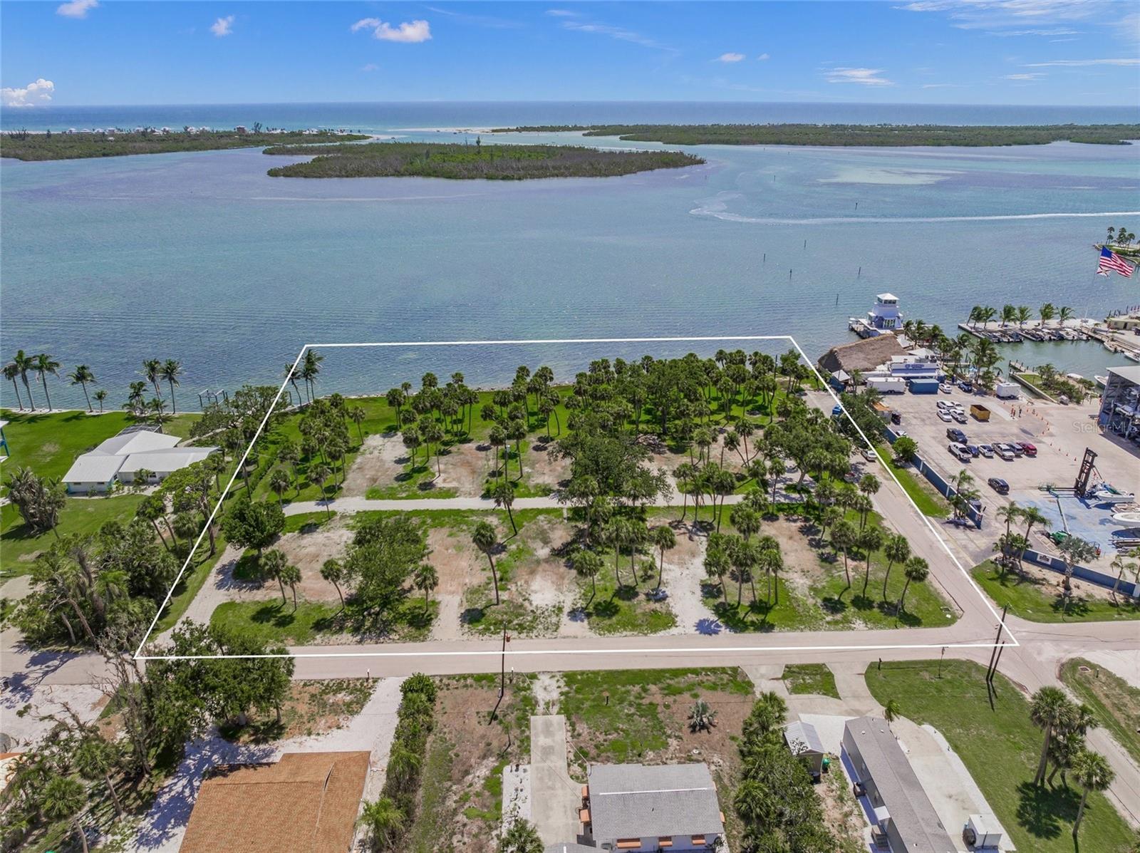 Spectacular bay front homesite or development opportunity. Over 330 feet of direct frontage on Lemon Bay with 2.3 +/- acres, zoned MHC (Manufactured Home Conventional). Gorgeous views of turquoise waters, stunning sunsets, endless wildlife, and phenomenal fishing. Potentials for subdividing into several large waterfront homesites, or developing multi-family residences. Stump Pass Marina and Lighthouse Grill are adjacent to the north and luxury residential bay front homes adjacent to the south. Multiple road frontages being on the corner of Maryland and Waterside Drive plus and Rasche Rd that runs through the property. Utility infrastructure includes 10 water meters and hookups, as well as electric service stubbed to the site. Fantastic location with the Gulf of America just minutes away, close Manasota Key and Englewood Beach, Palm Island, historic Boca Grande, Dearborn Street district, excellent dockage next door at Stump Pass Marina, lots of big shopping and restaurants close by. Englewood is a high growth area with tremendous commercial and residential development. HW41, Venice, Sarasota, and North Port are quick, easy drives to the north.