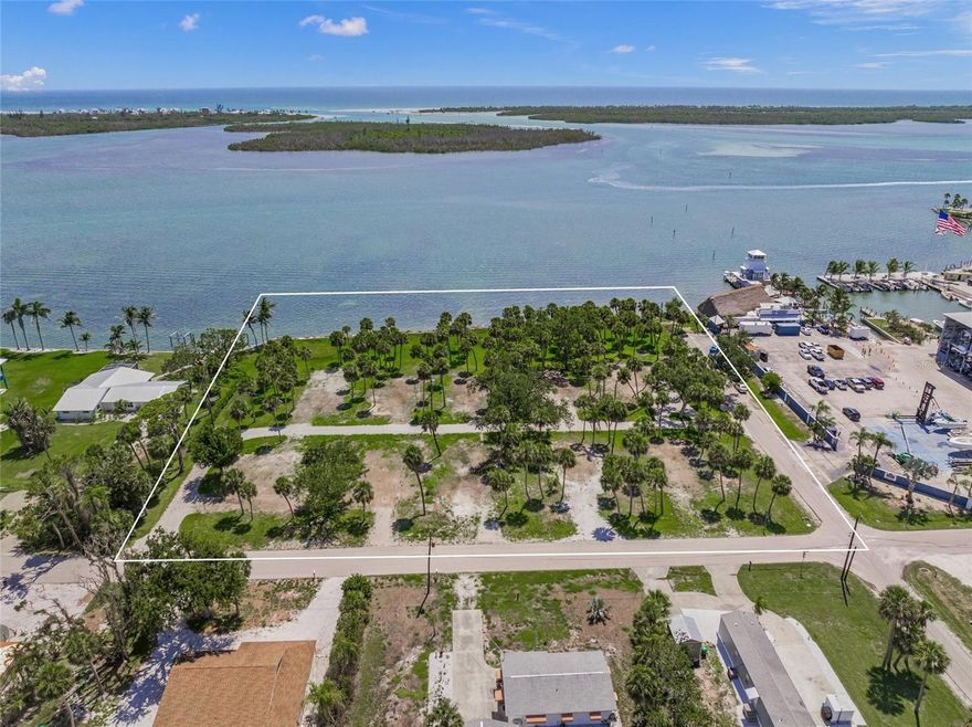 Spectacular bay front homesite or development opportunity.  Over 330 feet of direct frontage on Lemon Bay with 2.3 +/- acres, zoned MHC (Manufactured Home Conventional).  Gorgeous views of turquoise waters, stunning sunsets, endless wildlife, and phenomenal fishing.  Potentials for subdividing into several large waterfront homesites, or developing multi-family residences.  Stump Pass Marina and Lighthouse Grill are adjacent to the north and luxury residential bay front homes adjacent to the south.   Multiple road frontages being on the corner of Maryland and Waterside Drive plus and Rasche Rd that runs through the property.  Utility infrastructure includes 10 water meters and hookups, as well as electric service stubbed to the site.   Fantastic location with the Gulf of America just minutes away, close Manasota Key and Englewood Beach, Palm Island, historic Boca Grande, Dearborn Street district, excellent dockage next door at Stump Pass Marina, lots of big shopping and restaurants close by.  Englewood is a high growth area with tremendous commercial and residential development.  HW41, Venice, Sarasota, and North Port are quick, easy drives to the north.