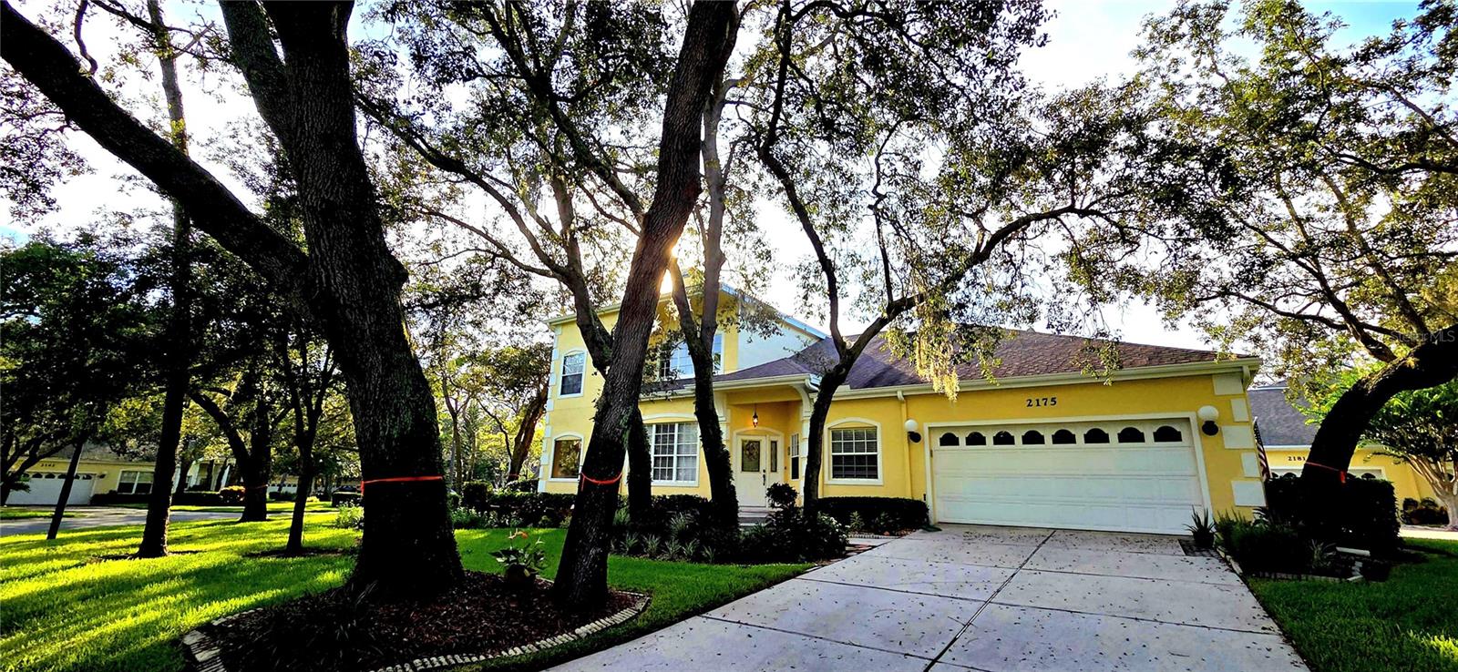 This stunning home is nestled in the gated community of Forest Retreat, located in Palm Harbor. The owner has meticulously maintained this lovely home. Step thru the stylish lead-glass entry door with sidelight that welcomes you into this lovely home with an open floorplan. The open and airy living room has high soaring ceilings, and plenty of windows, along with a cozy wood burning fireplace. The French doors leading out to the screened porch area that bathes the home in sunlight with views of open green space! A spacious kitchen with lots of cabinets, newer appliances and a serving area with pass thru, prep area, or workstation. Off of the kitchen is the formal dining room with a built-in wet bar area. The pampering Master bedroom suite is located on the first floor that is super spacious with large mirrored, his & her closets. A double vanity with dual sinks, Jacuzzi tub, a separate walk-in shower, and a private water closet. Up the prominent wooden staircase to the second story is an open loft area that can be an office/ bonus/games room or can be converted to 3rd bedroom. Just across the hall is an oversized 2nd bedroom with an en-suite bath, large vanity and makeup counter. This bathroom has a tub / shower with doors. The laundry closet has a mud tub and front-end loader and dryer for all your cleaning needs. A 2-car garage is attached right off the kitchen as well as a powder room. The home has meticulous gardens surrounding the home. Forest Retreat community offers a pool, hot tub, and covered pavilion area. This home is Florida living at its best! All within close proximity to the Beaches, Airports, Tarpon Springs Sponge Docks, Honeymoon Island State Park, Dunedin Causeway, highly rated schools, shopping, and restaurants.