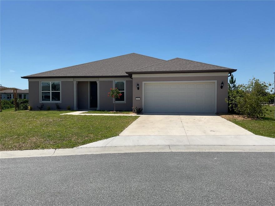 Experience the best of Ocala in this meticulously crafted single-family residence, completed in 2023. Boasting 2 spacious bedrooms with a large flex room and 2.5 bathrooms, this 2,261-square-foot home is designed for both comfort and sophisticated entertaining. The open-concept layout features durable concrete block and stucco construction with a classic shingle roof, ensuring peace of mind for years to come.The open-concept layout is designed for seamless indoor-outdoor living, highlighted by hide-away sliding glass doors that disappear to reveal a private lanai. This architectural detail frames a stunning, unobstructed view of the lake and the community clubhouse, perfect for morning coffee or sunset cocktails. Practicality meets hobbyist dreams in the oversized garage, which features dedicated space perfect for an extra storage area or a custom workshop. Nestled within the Stone Creek by Del Webb subdivision, this property grants you access to an unparalleled lifestyle. Residents enjoy a gated, guard-protected environment filled with resort-style amenities, including a premier golf course, a state-of-the-art fitness center, a sparkling community pool, and courts for pickleball and racquetball. Whether you're dining at the on-site restaurant or exploring the community's scenic trails, this home offers more than just a place to live—it offers a community to belong to.
