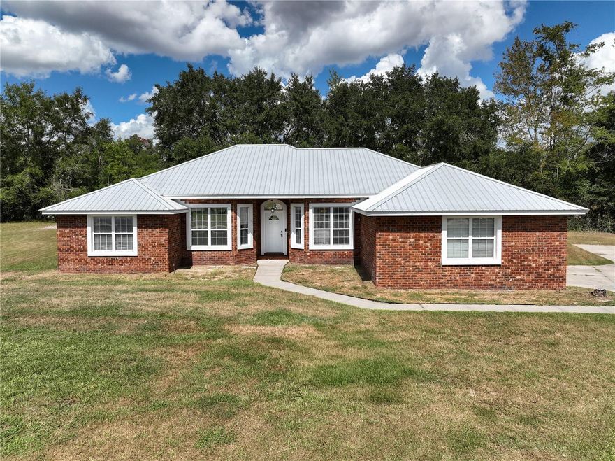BEAUTIFUL BRICK HOME ON CUL-DE-SAC IN HIGHLY SOUGHT-AFTER NEIGHBORHOOD — NO HOA! Welcome to this well-maintained 4 bedroom, 2 bath home perfectly positioned at the end of a quiet cul-de-sac in one of Lake City's most desirable neighborhoods. Sitting on a spacious half-acre fenced lot, this home offers both privacy and convenience, just minutes from local schools, shopping, restaurants, Lake City Medical Center, and I-75. Step inside to a wide-open living area with a split floor plan that offers ideal flow and functionality. The home features a brand new 2023 metal roof, and HVAC, 2025 Hot Water Heater, freshly painted interior, and a two-car garage with a new garage door motor and remotes. You’ll appreciate the professionally installed laminate flooring throughout the living areas, with extra pieces included for the buyer. The kitchen is equipped with stainless steel appliances, and the spacious master suite includes his-and-hers vanities and a large garden tub. Additional the septic and drain field system was updated in 2016 with regular monthly treatments. The backyard is partially fenced and backs up to a wooded area and peaceful retention pond, providing the perfect setting for outdoor enjoyment.  This beautiful brick home in a no-HOA neighborhood is move-in ready and offers everything you’ve been looking for. Don’t miss your chance—schedule your private showing today!