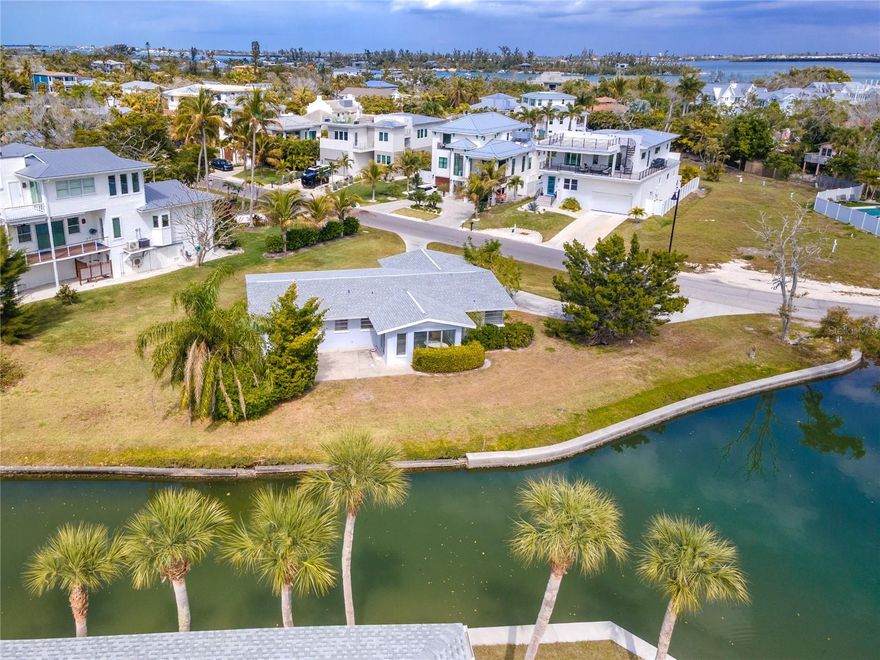 Discover one of the most coveted parcels in Longboat Key, located in the desirable Longbeach on Longboat Key community! This exceptionally spacious (.43 acre) and private corner lot sits where a calm canal flows into the scenic bayou, offering a truly unique waterfront setting with an extraordinary 243 feet of water frontage - a rare offering in the area. Imagine a custom estate with panoramic water views, multiple private dock possibilities, and  direct effortless boat access to the bay within minutes. The lot’s corner position maximizes privacy, natural light and breezes, and provides wide sightlines down the waterway for spectacular sunrises and peaceful evenings over the bayou.