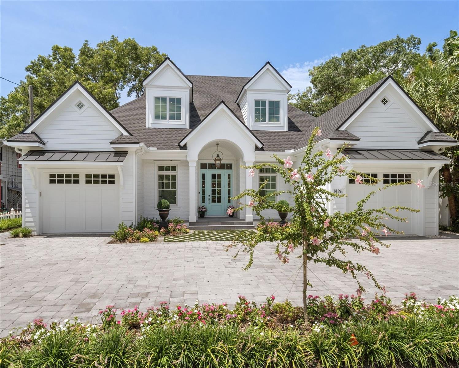 Perfectly located near the prestigious Southside Village and only minutes to downtown Sarasota, this custom-built home by Jonas Yoder offers elegance coupled with today’s most desirable style. Featuring over 3,000 square feet of beautifully crafted living space this home boasts of four bedrooms and four bathrooms with bespoke designer finishes throughout. The heart of the home is a chef's gourmet kitchen, equipped with high-end Thermador appliances, including a wine refrigerator and large pantry with built in custom cabinetry. The generous living area, with a backlit feature wall boasts a unique fireplace and flows seamlessly into the outdoor spaces, creating a perfect blend of indoor-outdoor living. A formal dining area with a sculptural light fixture enhances the space. Step into the expansive first floor owner's suite, a true retreat that combines luxury and comfort. Flooded with natural light, the bedroom offers serene views and ample space for relaxation. The suite features not one, but two generously sized walk-in closets, providing plenty of storage. The elegant bathroom is beautifully appointed with classic finishes, offering double vanities, a luxurious soaking tub, and a spacious walk-in shower. Two additional ensuite bedrooms with large closets upstairs, and an additional storage space in the hallway. A fourth bedroom/office downstairs provides additional flexibility. Outside, you'll find a resort-style pool surrounded by a low-maintenance turf lawn, illuminated by a low-voltage lighting system. The outdoor kitchen is an entertainer's dream, complete with a gas grill, sink, and refrigerator, ideal for hosting gatherings in your private backyard. Relax on the covered porch with automatic screens, providing comfort and shade. The exterior is a classic and timeless design and features a charming Bevolo gas light to welcome into this impeccable home. This home combines modern luxury with timeless elegance, set in one of Sarasota's most sought-after neighborhoods, making it a true masterpiece. With the location being outside of the flood zone along with its close proximity to Morton’s Market, approximately 17 restaurants within walking distance and access to beaches nearby, this home is absolutely perfect!