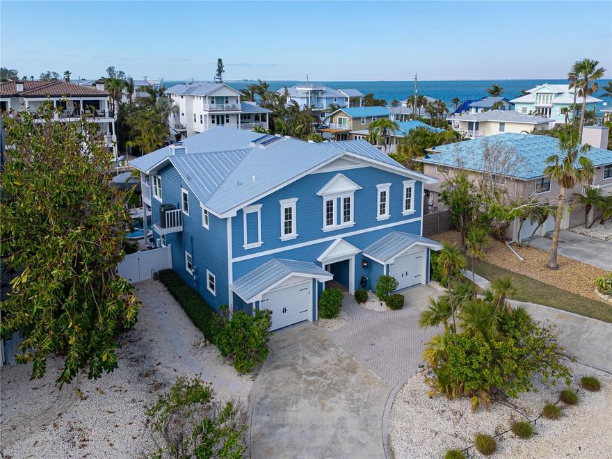 This newly remodeled home in the center of Anna Maria Island is just a short stroll to Pine Ave with all its shops and restaurants. The beach is right down the street.  This home has so many beautiful features and a wide open floor plan for entertaining guests.  Each bedroom has its own walk-in closet and master bath with designer fixtures. The back upper deck is the width of the entire home and has a back porch swing and lots of seating areas.  The lower porch runs the entire width of the home also and is covered and looks out to the beautiful pool area with its many seating areas for large gatherings.  The backyard has one of the largest pools on the island and has new landscaping and palms . The pool and spa have new equipment with a new pool pump and heater.  Come bring your boat- there is a new raised seawall , dock and 16,000 lb boat lift-  No bridges to the open water.   The metal roof was installed in 2019 and the outside was just freshly painted. There is a circular  drive and two separate garages that will hold multiple cars and golf carts.  Come see why this is one of the worlds top 10 destinations to vacation. And then imagine being able to live here in your own private paradise.