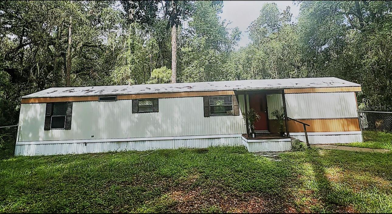 Welcome to 3080 CR 417 in beautiful Lake Panasoffkee! This charming 2-bedroom, 2-bath manufactured home has been recently refreshed with new flooring in the main living areas, fresh interior paint, updated lighting fixtures, and a recently cool-sealed roof. The inviting floor plan features a bright kitchen that opens to the living and dining space, making it ideal for comfortable everyday living.
Enjoy outdoor living with a fenced front yard, covered entry porch, and plenty of yard space. The property also includes a storage shed and convenient parking. Located just minutes from Lake Panasoffkee, I-75, and local amenities. (Additional Pictures Coming Soon)