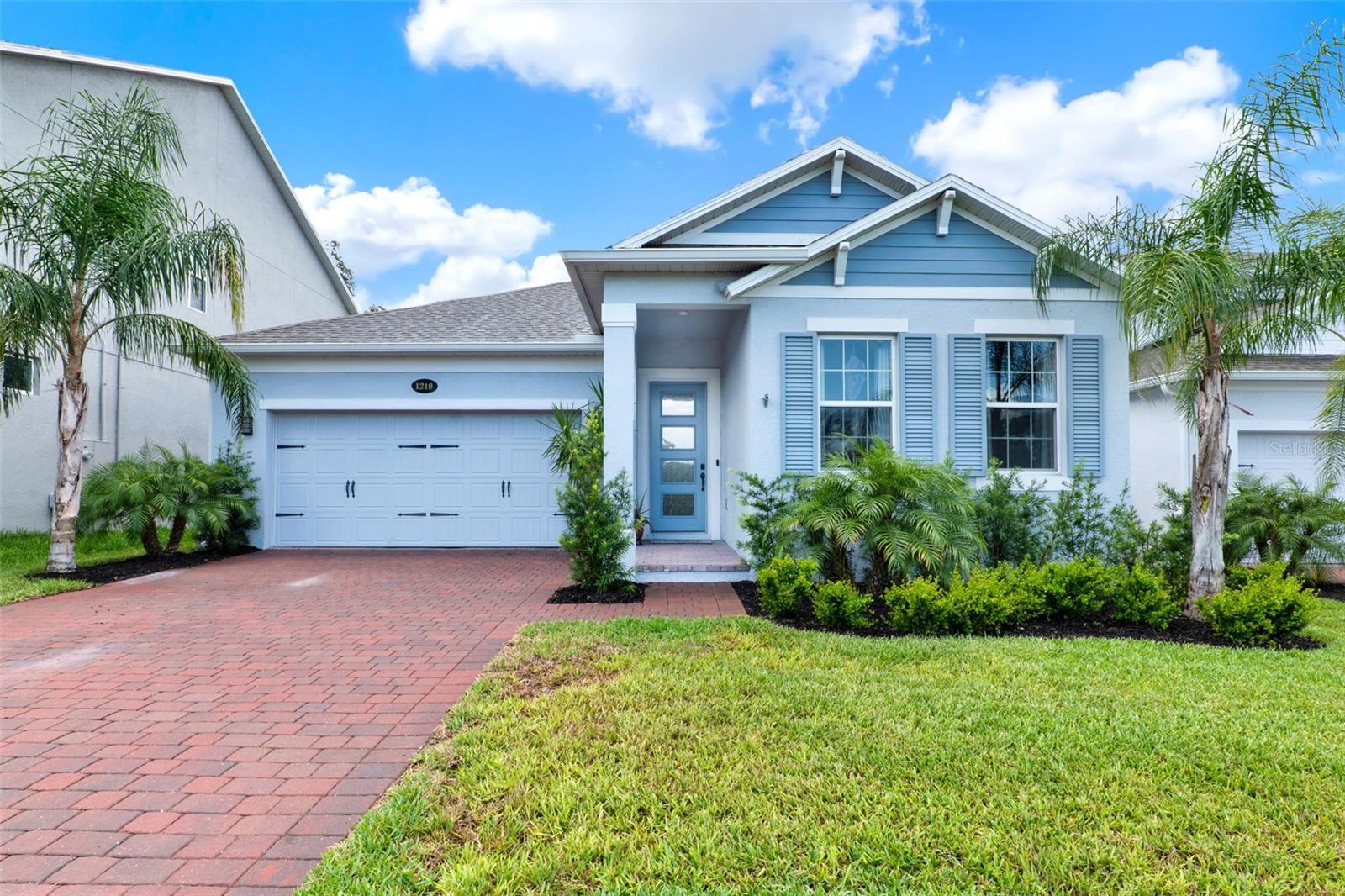 Step into this exquisite ONE-STORY residence, where love at first sight is inevitable. Nestled in the serene, LAKEFRONT community of Hull Island, this home offers enchanting VIEWS of the NATURE PRESERVE and is ideally located within close proximity to Winter Garden’s historic downtown, the charming town of Oakland, and the lively town of Clermont. Here, you’ll relish waterfront dining, local shopping, vibrant Farmers Markets, and an array of weekend events. With its inviting front porch, carriage-style garage doors, and elegant brick paver driveway, this home exudes a timeless charm, reminiscing to an era of grace and simplicity. Inside, the 3-bedroom, 2-bath layout is designed for comfort and style, featuring a 2-car garage, a spacious extended LANAI with retractable screens, and sophisticated custom trim and lighting. Wood-like tile floors and pristine QUARTZ countertops add a touch of refinement throughout. The heart of the home is the expansive L-shaped kitchen, a culinary dream with an island, stainless steel appliances—including a gas range—under-cabinet lighting, sleek tile backsplash, and a convenient coffee bar. The cabinetry offers ample storage, complemented by an oversized walk-in pantry with custom shelving for all your organizational needs. This open-concept space seamlessly connects to the breakfast area, living room, and lanai, making it ideal for both intimate gatherings and large entertaining. Step outside to the wrap-around extended paver lanai, where two retractable screens invite you to enjoy alfresco dining or game day fun. Inside, the cozy living room, enhanced by electric LEVOLOR shades and a stunning feature wall with built-in cabinetry and accent lighting, promises an atmosphere of warmth and elegance. The generously sized PRIMARY suite, located at the rear of the home for privacy, is bathed in natural light and features a tray ceiling and accent wall, elevating the space with a touch of luxury. The spa-inspired primary bath offers a double vanity, relaxing garden tub, a spacious walk-in shower, a private water closet, and a walk-in closet for your wardrobe needs. On the opposite end of the home, two additional bedrooms share a well-appointed bath with a tub/shower combination and a convenient linen closet. The laundry room, located in the hallway, offers style with a drying rack and storage cabinet. This 2022-built home includes thoughtful features such as a tankless water heater, custom mirrors and lighting, and polyaspartic garage flooring. The community itself is a haven for nature lovers, with a sparkling POOL, charming gazebo, and a picturesque boardwalk leading to a fishing pier offering breathtaking views of Lake Apopka. Enjoy the park and playground, dog park, and a private entrance to the 120+ acre Oakland Nature Preserve, complete with winding trails. For those who appreciate outdoor adventure, the 22-mile West Orange Trail is nearby, as well as easy access to major highways (Turnpike, 408, 429), shopping, dining, three vibrant towns, golf courses, tennis and pickleball courts, and Orlando’s world-class amenities, including the international airport, theme parks, and beaches. This is more than just a home—it's a lifestyle. Seize this rare opportunity to own your own slice of PARADISE.