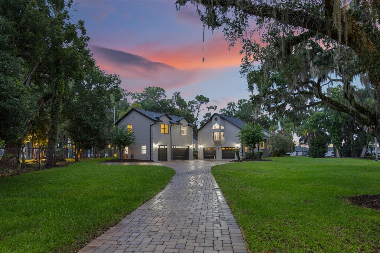 This approximately 4200 square foot home is situated on a 1.68-acre gorgeous lakefront lot in the desirable Winter Park area. The property features a completely updated main house with five bedrooms and three and a half bathrooms, flex room to be used as an office,
game or exercise room, total of five-car garage and additional storage in the basement. The three-car air-conditioned garage is
as a car collector's dream. The primary bedroom suite offers a tranquil retreat, with modern features, ample square footage and
completely remodeled en suite bathroom. The remaining two bedrooms with remodeled hall bath provide comfortable
accommodations for family and guests. The updated and remodeled interiors showcase a warmi, modern, inviting ambiance,
with thoughtful design elements throughout. The open floor plan allows for seamless indoor-outdoor living, with access to the
lakefront and private boat dock. The lakefront location offers unparalleled privacy and access to the serene waters, creating a
serene and peaceful living environment. The property's unique features, including the updated interiors, separate living spaces,
and prime lakefront setting, make it an ideal choice for those seeking a distinctive and well-appointed home.
Some of the upgrades include new roof in 2022, New HVAC systems in 2022, new water heater in 2022, new kitchen in 2024, new bathrooms in 2024, new designer light fixtures throughout the house in 2024, upgraded flooring in 2022, new expanded back porch deck in 2022 with stunning views of lake and natural setting, new interior paint in 2024, new exterior paint in 2022, upgraded mother-in-law, guest house, office space, separated rental or teenager's retreat, new boat lift in 2022, new paver driveway in 2022, new water softener in 2022. No HOA restrictions.