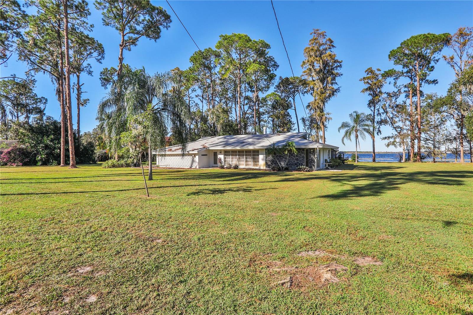 Unique, One-Of-A-Kind, Stunning Triple Lot Property Offering A Unique Opportunity To Build Your Dream Home Just Minutes From The Sought-After Dr. Phillips Area with No HOA! Prime Water Frontage On the Amazing Butler Chain Of Lakes! House is Dated but can be Lived In As Is. Listing Priced Based on Land Value. This Expansive Lot Provides The Ideal Foundation For A New Custom Lakefront Estate. Imagine A Home Where Floor-To-Ceiling Windows Capture Breathtaking Lake Views, Expansive Patios Bring Outdoor Living To Life, and a Private Dock Lets You Launch Your Boat Or Kayak Right From Your Backyard. This Property Gives You The Freedom To Design A Space That Fits Your Vision Of Lakefront Luxury. Located Near The Vibrant Dr. Phillips Area, This Property Places You Close To Upscale Shopping, Acclaimed Dining, And Top-Rated Schools. Known For Its Community Charm And Convenience, Dr. Phillips Is One Of Orlando’s Most Desirable Neighborhoods, Offering The Perfect Balance Of Tranquility And Accessibility. Bring Your Dream Lakefront Home To Life, With Direct Access To The Butler Chain Of Lakes And The Best Of Central Florida Just Moments Away. Don’t Miss This Chance To Create A Custom Retreat In A Truly Unbeatable Location! LISTING INCLUDES LOTS 2, 3 AND 4.