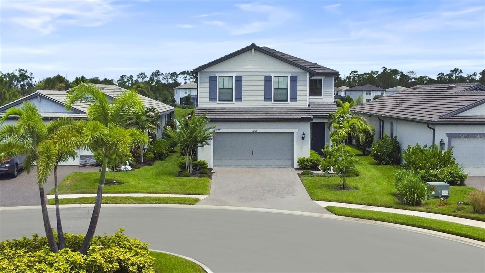 A 5-bedroom, 3-bath home in Lakewood Ranch might not be that rare, but finding one tucked at the end of a quiet cul-de-sac with a peaceful water view right in the backyard? That’s something special that rarely comes on the market. Spend your days enjoying the vibrant community amenities—whether it’s swimming, working out, or gathering with neighbors—and return home to the quiet and privacy of your cul-de-sac.
Welcome to 6256 Baywood Ct, a beautifully located and well-finished Pulte Trailside model in the gated, resort-style community of Sapphire Point. This spacious and modern 5-bedroom, 3-bath home offers the ideal blend of resort-style amenities, privacy, and comfort.
The heart of the home is the open-concept kitchen and living area, where granite countertops, premium KitchenAid stainless steel appliances, a large center island, and ample cabinetry meet bright, airy living spaces that flow seamlessly into the dining area and family room, all overlooking the backyard and tranquil water view.
Upstairs, you’ll find four generously sized bedrooms, including a spacious owner’s suite with calming water views, a large walk-in closet, and a spa-like en-suite bath featuring an oversized walk-in shower.
The laundry room is conveniently located on the second floor, along with a spacious loft that works well as a media room or playroom.
On the main floor, a fifth bedroom and full bathroom provide the perfect setup for guests, in-laws, or a private workspace, offering flexibility to meet your lifestyle needs.
Step outside to your covered and screened lanai, a peaceful place to relax, entertain, or enjoy Florida’s beautiful weather with a waterfront backdrop.
Additional highlights include a whole-house water filtration and softener system that provides clean, filtered water from every faucet and a spacious two-car garage with a 4-foot extension, electric (EV) car charger and premium epoxy floor, ideal for extra storage, a home gym, or a workshop.
As a resident of Sapphire Point, you will enjoy access to top-tier amenities including a resort-style pool, clubhouse with community room and kitchen, state-of-the-art fitness center, basketball court, covered pavilion, and fire pit, all set within a beautifully landscaped, gated community.
Located just minutes from top-rated schools, shopping, dining, and major highways, this home offers both convenience and quiet, situated on one of the most desirable lots in the neighborhood.
Homes like this, offering five bedrooms, three bathrooms, cul-de-sac privacy, and a backyard water view, rarely come available. Don’t miss your chance to make it yours.