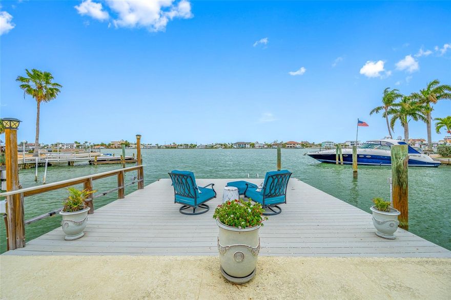 Luxurious Waterfront Sophistication Near St. Pete Beach. This rebuilt, white-and-bright waterfront retreat features 3 bedrooms and 3.5 baths plus  an Office/Den, All new throughout, and sits within easy strolling distance to the sugary sands of St. Pete Beach. Every surface has been remodeled to pristine perfection, from the chef’s kitchen with a magnificent island and seating for family and guests ,complete with custom cabinetry and a large walk-in pantry.Expansive panoramic windows flood the home with natural light and complement the high ceilings giving the home an airy feel of space, ZEN and Luxury.  Large Bedroom with direct access to the outdoor pool area  and en-suite bath and 2 additional well sized bedrooms on the main floor with lots of closet space. Inviting Primary suite on the second floor with en-suite full bath and large office/living space, lots of privacy.The property showcases  Anderson hurricane-impact windows and doors for uncompromising security and energy efficiency, a metal roof updated in 2010, and a comprehensive remediation and renovation that elevate safety, durability, and modern luxury. Indoor-outdoor living is seamless with direct waterfront access and sun-washed horizons visible through floor-to-ceiling windows, while immaculate finishes and abundant storage enhance both elegance and practicality. Outside, enjoy a gorgeous waterfront solar-heated pool surrounded by tropical landscaping and a inviting paver deck, perfect for lounging or entertaining while savoring panoramic water views. Located in a tranquil yet convenient beach corridor, this turnkey residence combines high-end craftsmanship with unmatched location, offering a sophisticated retreat that captivates with light, flow, and panoramic coastal views. Schedule a tour to experience the luminous ambiance and refined ambiance this home delivers. More pictures to follow.