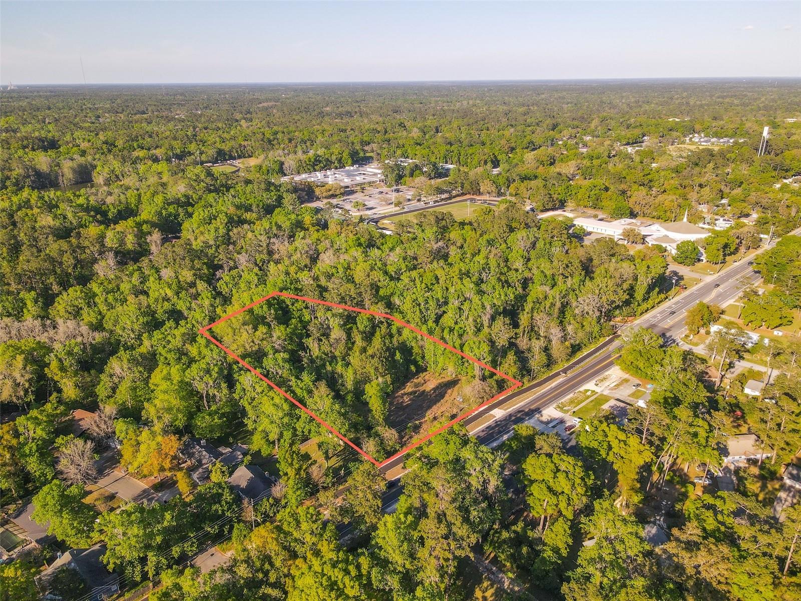 This three acre beautiful lot is a prime location for luxury townhomes or an exclusive single family home development in the heart of NW Gainesville. Zoning was previously approved for 11 townhomes, but could be modified to single family homes. 300 feet of road frontage on refinished NW 23rd Ave which includes a new multi use trail. 1.59 acres are developable with the remaining acreage set aside in conservation. The area includes million dollar homes and is zoned for A-rated schools Meadowbrook Elementary, Fort Clarke Middle School. Fresh Market, Publix, Uppercrust Bakery and Millhoper shopping center are a mile away. Major job centers HCA North Florida Hospital and Santa Fe College are less than two miles away, and the University of Florida, UF Health, Butler Plaza, and downtown Gainesville are within 15 minutes. Beautiful views into a County owned conservation area which surrounds the property on two sides and includes a creek and lake. Includes parcel ID # 06152-011-000 and 06221-000-000