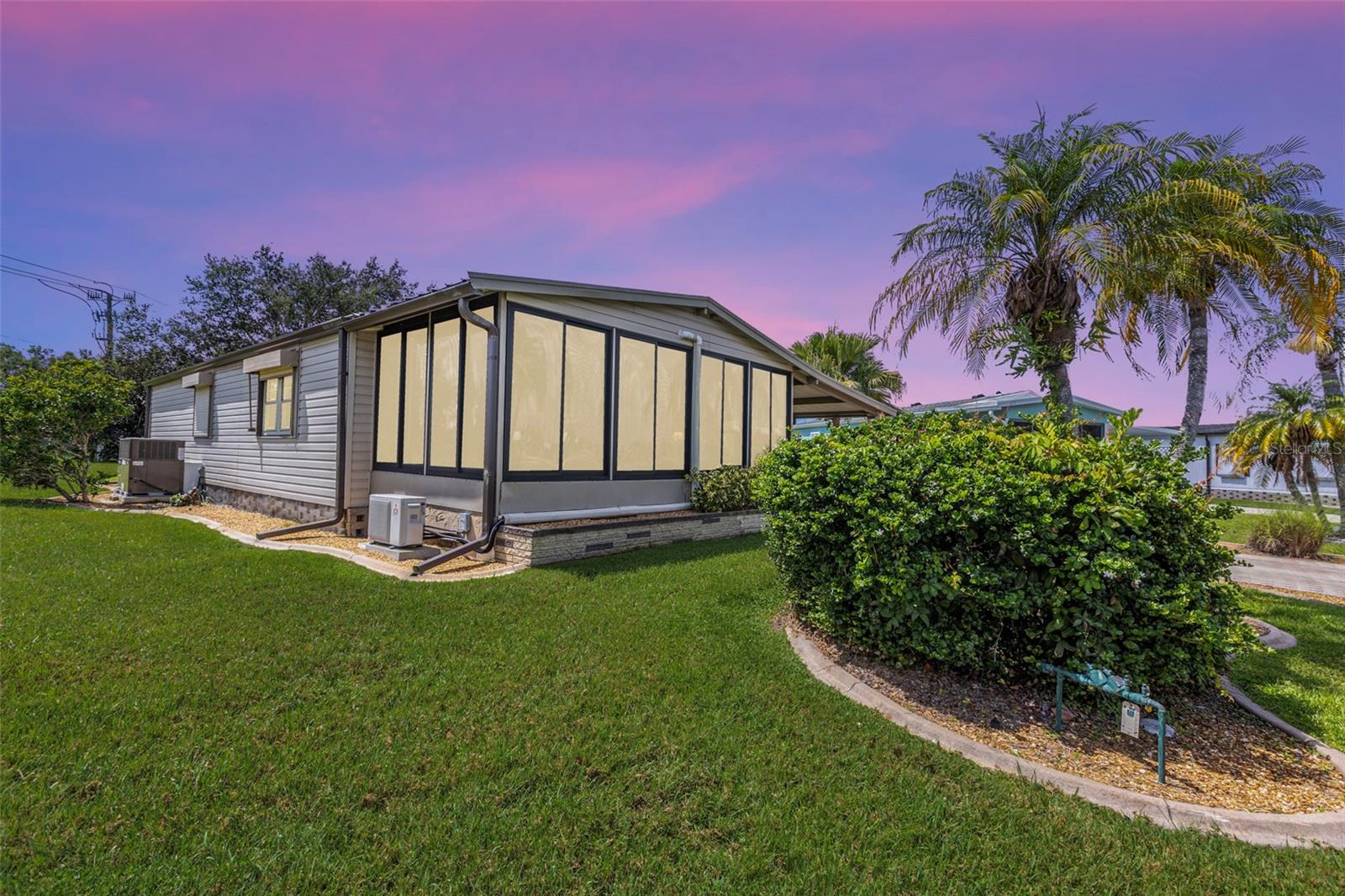 Beautifully maintained 2-bedroom, 2-bath home featuring a carport with bricked pillars that leads to a screened and vinyl-enclosed lanai with a decorative tile floor. The utility room is equipped with a washer, dryer, storage space and additional outdoor closet for extra storage. The kitchen boasts a pantry, new cabinets, appliances, and luxury laminate flooring. The dining room includes a built-in hutch, while the living room has French doors that open to the front, leading to a tiled, acrylic-enclosed Florida room that comes with a separate A/C unit. The guest bedroom features a walk-in closet, and the remodeled guest bath includes a vanity with a vessel basin and a tub/shower combination. Double doors lead into the primary suite, which includes a walk-in closet and a dressing area with a double-sink vanity. The primary bath features a Roman shower with a bench. The property is equipped with storm shutters throughout, and the A/C system was replaced in 2019, complete with a 10-year transferable parts warranty. The roof was recently replaced in March 2023. Located on a pie-shaped lot, the home offers a private backyard area. Welcome to La Casa, an enchanting community where 974 exquisite homes are beautifully set among native trees, surrounded by spacious common areas and eight serene lakes. Our generous 60 by 80-foot lots can create your ideal space. Perfectly located between Sarasota and Fort Myers, La Casa is a boater's paradise with direct access to the stunning Gulf of Mexico. Enjoy easy access to shopping, sightseeing, golfing, and fishing, all while immersing yourself in the rich culture of Southwest Florida. Experience the warmth of Southwest Florida’s winters in a relaxed environment, far from the east coast hustle. Our lush, mature landscaping reflects the dedicated care of residents and management. La Casa features some of the finest pools in the area, including our magnificent 40 by 60-foot swimming pool, maintained at a delightful 87 degrees, and a cozy 20 by 40-foot pool nestled between the clubhouse and Activity Building, both with inviting hot tubs. Stay connected with our complimentary Wi-Fi at the Clubhouse, Activity Building, and Recreation Hall while you soak up the sun. La Casa is a family-friendly haven where you can enjoy tranquility while remaining close to vibrant attractions. Come visit our charming oasis and discover why La Casa is the ultimate destination for snowbirds and year-round residents!