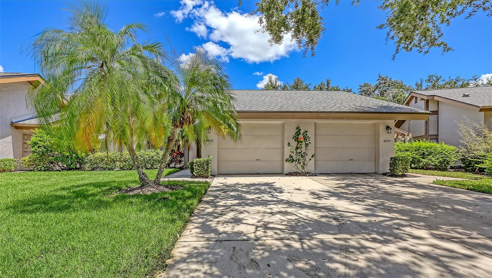 Welcome to this beautifully updated 2-bedroom, 2-bath villa in the highly desirable Kingsmere community within The Meadows—offering one of the most sought-after, expansive golf course views! Step through a sunny, private courtyard into a bright and airy interior featuring cathedral ceilings, skylights, and a large picture window that frames the lush golf and nature scenery. The open-concept layout enhances the sense of space, perfect for relaxed Florida living. The stylish kitchen includes wood cabinetry, granite countertops, travertine tile, and sliding glass doors that lead to the courtyard—ideal for al fresco dining. The living and dining areas, along with the second bedroom, showcase rich wood flooring, while the spacious primary suite features neutral carpet and a remodeled en-suite bath. Additional highlights include: 2024 Roof, 2020 Stainless Steel Appliances, 2019 A/C and Water Heater, Fresh Interior Paint, Oversized Laundry Room with Extra Storage, Deep Attached Garage—perfect for storage or hobbies. Kingsmere is an intimate enclave of just 57 villas that are maintenance-free and feature a beautiful community pool. Nature lovers will appreciate nearby walking trails, butterfly gardens, pickleball courts, and Benderson Park. With quick access to University Parkway, UTC Mall, Whole Foods, Deitwilers Farm Market, minutes from trendy and thriving downtown Sarasota, area beaches including Siesta Key, Longboat Key, Venice and Bradenton, this move-in-ready villa is perfect as a primary residence or vacation home. Don’t miss this rare opportunity to own a piece of paradise in The Meadows!