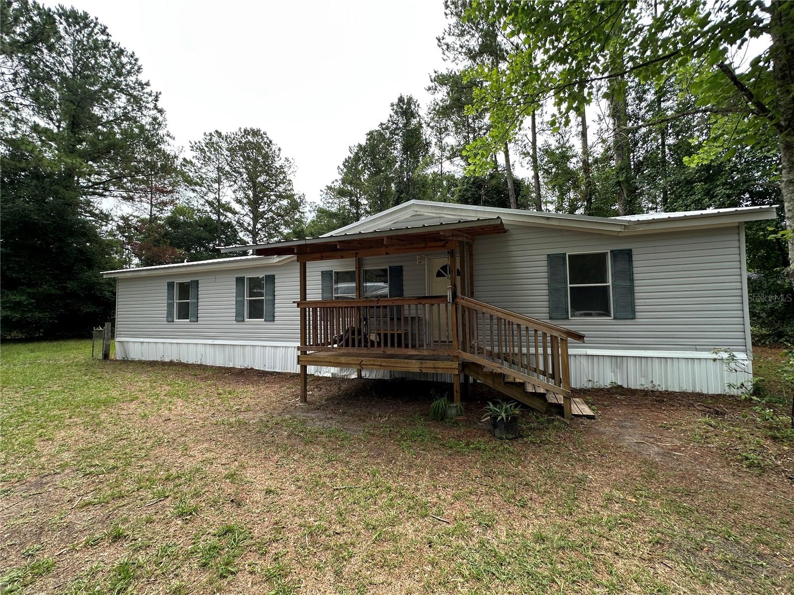 2005 Manufactured Home with 3 bedrooms and two bathrooms with a bonus room. The house features a covered porch and a new Central AC system. At the entrance is a large living room, with a large kitchen and dining area. House has a split floor plan with a large primary bedroom with a large master bathroom, including two sinks, a tub and a shower. The house has all new vinyl flooring throughout the house and has been freshly painted on the interior. The property is a half acre in size and there is an on-site water well and septic. A new AC system was installed during May of 2025 and the Septic Tank was just pumped out.