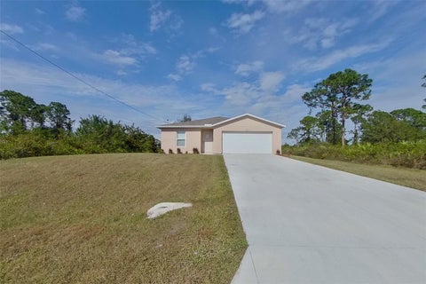 Photo of 855 Cervantes Street E, Lehigh Acres, FL 33974 (MLS # O6448468)