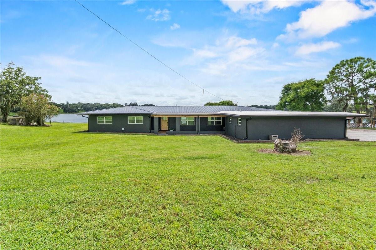 Welcome to 1 Horne Road in Bartow, FL — a fully remodeled lakefront retreat blending modern upgrades with timeless charm. Nestled on 2.49 acres with 90 feet of frontage on Star Lake, this home offers peaceful water views, privacy, and the rare benefit of being the only residence on the road. The county maintains the road, adding convenience and peace of mind.
Step inside to discover 4 bedrooms, 3 bathrooms, and over 3,300 sq. ft. of thoughtfully designed living space. Fresh paint inside and out, new crown molding, updated windows, a new front door, and brand-new ductwork give the home a crisp, move-in ready feel. The master suite has been completely redesigned with a beautifully remodeled bedroom for your comfort. One of the other bedrooms serves as a secondary primary with its own private bathroom, perfect for guests or multi-generational living.
The exterior has been just as carefully updated with a new metal roof (with a 3-year transferable workmanship warranty and transferable roof warranty), new soffit and fascia, fresh stucco, and a new pole barn. The former carport has been enclosed to create a functional garage, adding storage and practicality. A 3-year-old well provides reliable water service, rounding out the list of thoughtful updates.
Bring all your animals — the land is already home to chickens, pigs, and goats, making it ideal for hobby farming or country living.
With no HOA and a setting that balances modern convenience with rural charm, this property is perfect for those seeking serenity, space, and exclusivity.