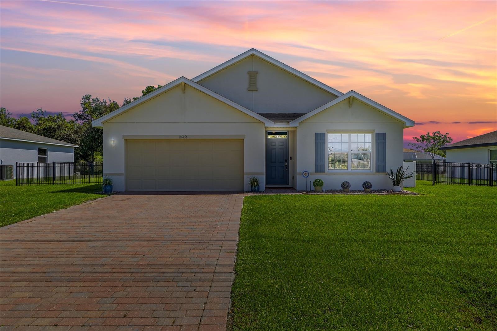 Welcome to this beautiful 2022-built home, perfectly positioned on a greenbelt lot in the sought-after community of Deep Creek. This well-maintained, deed-restricted neighborhood offers a low annual HOA of just $200 and features amenities like a community park, sidewalks, tennis and pickleball courts, a basketball court, playground, and a scenic golf course—ideal for an active Florida lifestyle. Inside, the home features a spacious and functional 4-bedroom, 2-bath layout with a two-car garage. The open-concept design includes a modern kitchen with white shaker cabinets, a quartz island with seating, and a large walk-in pantry—all overlooking the dining and living areas, making it perfect for both everyday living and entertaining. Enjoy the outdoors from your extended screened lanai, perfect for relaxing or hosting guests, and take advantage of the fully fenced backyard, ideal for pets, play, or added privacy. The split floor plan provides privacy, with the primary suite offering a generous walk-in closet and a private en suite bath with dual sinks and a walk-in shower. Tile flooring runs throughout the main living areas for easy maintenance, while the bedrooms offer cozy carpeting. A dedicated laundry room adds everyday convenience. Located near I-75, Kings Highway, shopping, dining, and medical centers—plus just a short drive to some of Florida’s most beautiful beaches—this home offers the perfect blend of comfort, location, and lifestyle.