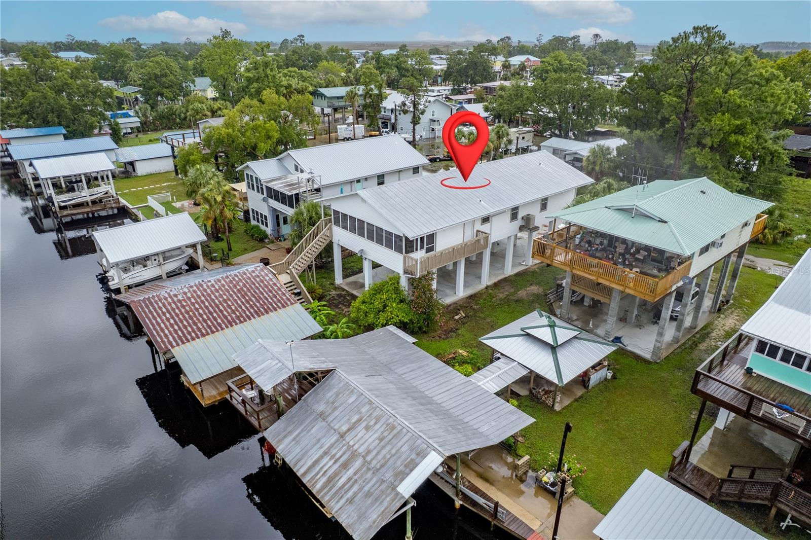 This charming 3-bedroom, 2-bath home in Suwannee, Florida offers the perfect blend of comfort and waterfront living. Located on a peaceful freshwater canal with direct access to the Suwannee River, this property is a dream for boating and fishing enthusiasts. Relax on the screened-in porch and enjoy tranquil views of the canal, or head out to your private boathouse, which features two boat slips and easy water access. A dedicated storage room includes a convenient fish cleaning station, making it easy to enjoy fresh catches right at home. Inside, the home offers a spacious and functional layout, ideal for full-time living or weekend getaways. Whether you're looking for a quiet escape or a base for outdoor adventures, this Suwannee home is the perfect place to call your own.