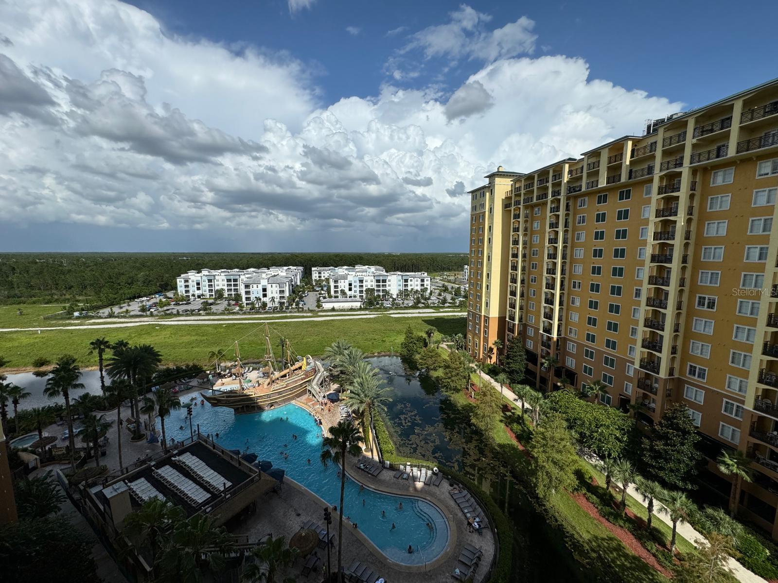 Welcome to 8125 Resort Village Dr Unit 51006 – a fully furnished 2-bedroom, 2-bath condo located in the award-winning Lake Buena Vista Resort Village & Spa. This spacious unit features an open floor plan with a modern kitchen, dining area, and living room, plus large sliding doors that open to a private balcony with stunning views of the iconic pirate-themed pool. The master suite includes a spa-like bathroom with a Jacuzzi tub, and the second bedroom and full bath provide plenty of space for guests. The unit comes fully equipped and is turn-key ready, ideal for short-term rental or personal use. Enjoy top-tier resort amenities including the Pirates Plunge pool, a second relaxation pool, full-service Reflections Spa & Salon, LBV Village Bar & Grill, Frankie Farrell's Pub, Pizza Hut Café Express, convenience store, gift shop, and scheduled shuttle service to Disney Parks. Additional features include a 24-hour fitness center, game room, kids' play area, high-speed internet, cable, and a la carte housekeeping. The resort has earned TripAdvisor’s Travelers’ Choice Best of the Best (2020) and Travelers’ Choice (2022) awards, making it a top destination for vacationers. With strong rental potential and financing available for both local and international buyers, this property is the perfect investment or vacation getaway in the heart of Orlando.