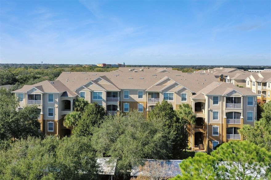 GORGEOUS FIRST FLOOR CONDO IN GATED COMMUNITY WITH THE MOST INCREDIBLE DESIGNER FINISHES. This home has it all from large stone look tile, gourmet kitchen with custom cabinets, solid surface countertops and GE Profile stainless appliances, new carpet in bedrooms, luxury bathrooms with custom cabinets and designer lighting and so much more! Two large bedrooms provide dual Primary suites with a third bedroom that could also be a home office or nursery. The open concept kitchen/dining/family room and high ceilings make entertaining a joy. NEW AC IN 2022!  Gorgeous high quality blinds throughout. The gated community features a resort style pool and clubhouse, parklike setting for lakeside walks, tennis court, gym, and playground. Conveniently located near attractions (Universal), Valencia, I-Drive, and fantastic dining and shopping options. The remodel was done for the owners' family (not "buy and flip" quality) and they spared no expense on quality upgrades, materials, and craftsmanship - COME SEE FOR YOURSELF WHAT SETS THIS HOME APART FROM THE REST.  All information and measurements are believed to be accurate but buyers should verify all.