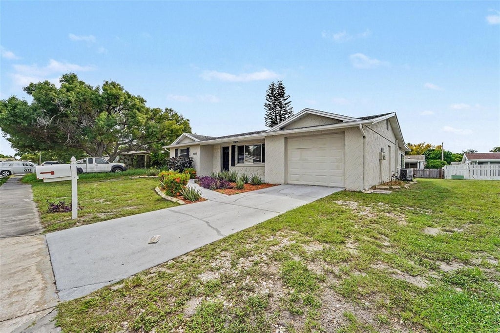 Photo of 9035 Saint Regis Lane, Port Richey, FL 34668 (MLS # O6445773)