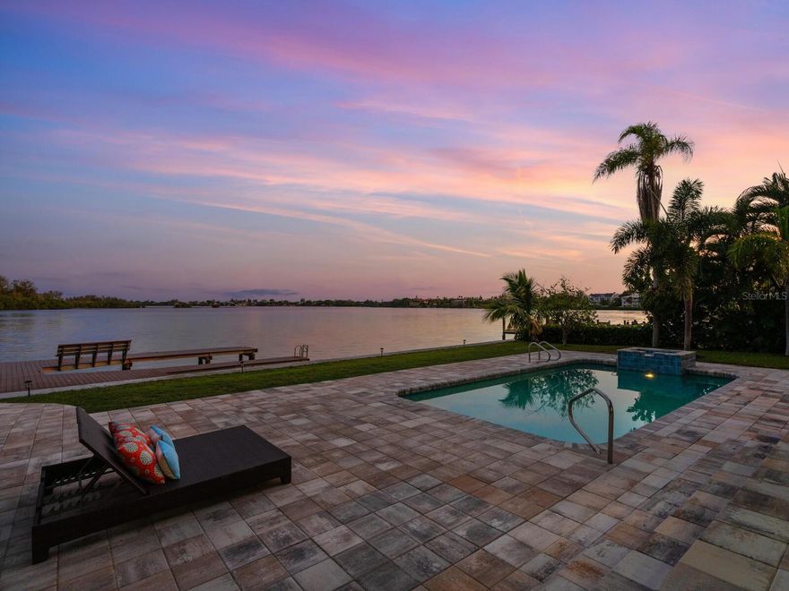Exquisite bayfront retreat. Nestled along the coveted shores of Siesta Key, this beautifully remodeled five-bedroom, five-and-a-half-bath residence epitomizes coastal luxury living. Radiating refined elegance and an unrivaled sense of tranquility, this home boasts captivating bay vistas and an enviable location on one of Siesta Key's most sought-after streets. Upon arrival, a covered entrance sets the stage for the splendor within. Majestic bay views greet you upon crossing the threshold, complemented by soaring ceilings that exude an ambiance of sophisticated allure. Abundant impact windows and sliding glass doors infuse the living spaces with natural light and a sense of serenity, and the wide-plank European white oak floors effortlessly merge casual relaxation with upscale refinement. The heart of this abode lies in its gourmet kitchen, a haven for culinary enthusiasts outfitted with premium appliances and bespoke cabinetry. Seamlessly connected to the living and dining areas, this space becomes a hub for intimate family gatherings and lavish entertaining affairs. Step out onto the sprawling two-story terrace, an al fresco haven where panoramic sunsets and gentle bay breezes become a daily indulgence. The first-floor primary suite, a serene sanctuary overlooking the bay, invites you to wake up to breathtaking views each morning. A spacious office and laundry room complete the main level. On the second level, the four thoughtfully crafted bedrooms, each boasting ensuite baths and ample storage, ensure privacy and comfort. Outdoor opulence awaits in the entertainer’s dream backyard, featuring a spacious yard and a sparkling pool enveloped by the Florida sunshine. Embrace the waterfront lifestyle with a new, to-be-built private boat dock, offering unfettered access to the glistening sailboat waters leading directly to the Gulf of Mexico, where dolphin and manatee sightings become part of your everyday vista. This prestigious haven on Siesta Key's northern tip exudes exclusivity and serenity, crafting an everyday retreat reminiscent of an everlasting vacation. Revel in the island lifestyle with Siesta Beach's renowned white quartz sands, the azure waters of the Gulf of Mexico, and the vibrant Siesta Village's offerings just moments away. Indulge in downtown Sarasota's cultural delights, dining, and entertainment within arm's reach. Don't miss this rare opportunity to own a piece of paradise in one of Siesta Key's most desired waterfront neighborhoods, where your coastal retreat awaits.