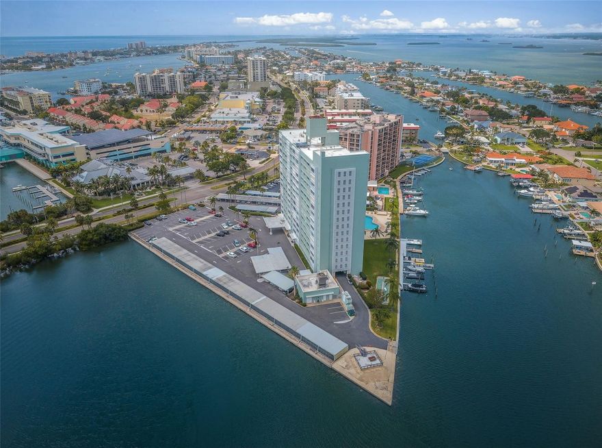 Start living 2026 on the ISLAND!  Whether it's your primary home or second home you won't find views any better than here!  And only minutes to the white sandy beach of Clearwater offering dining, shopping and laid back fun!  Island Estates is one of the most sought-after enclaves in the Clearwater Beach region. Comprising four islands and a charming retail area that includes a unique Publix market and a variety of shops, it also features the amazing Clearwater Marine Aquarium, neighborhood eateries including the famed Island Way Grill. Seconds from the Clearwater Memorial Causeway and minutes from one of the most beautiful beaches in the world, biking and running trails, as well as Imagine Clearwater, the newer 24-acre waterfront park/plaza with covered amphitheater, this one-time hurricane shelter was purchased by residents in the early 1960s to create a distinctive dwelling. Nestled on the intracoastal, off Florida’s mainland, a panoramic water landscape lends the shoreline experience to this lovely 1 bedroom/1 bath home. The amenity-rich building includes private storage closets off every hallway to accommodate seasonal décor and supplies, complimentary laundry rooms on each floor, boat slips on a first come first serve basis with an additional monthly fee, bike storage, a glistening geo-thermal heated pool framed by chaises, a fishing pier, grilling stations, and The Point: a waterfront structure that offers yet another tranquil place to unwind. An incredibly spacious lobby boasts comfy furniture, views of the pool, a secure package room, a lending library, a community kitchen, and a huge multi-purpose meeting room. A variety of clubs and activities are run by residents while several committees are available to feed your volunteer's soul. Impeccably managed by its full-time, onsite property manager and staff, the monthly fees include basic cable, lobby Wi-Fi, electric, water, sewer, trash, and building maintenance. The dedicated board of directors have initiated some tremendous cost savings and improvements to benefit the shareholders’ investment including energy efficient boilers, upgraded A/C and elevators, NEWER fitness center, NEWER entry security, and NEWER Miami Dade spec windows on the lobby level. Inside this cozy unit on the sixth floor, walk into the “wow factor” where floor to ceiling sliders reveal dramatic water vistas.