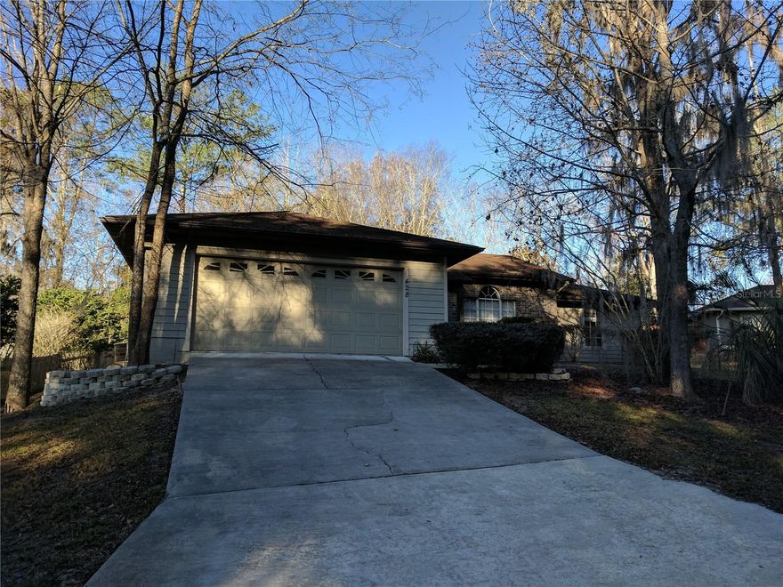 This property is a single family 3bed/2bath split plan home w/ large partially fenced back yard in Hamilton Pond. New flooring was installed in December 2025. The Family/living room is open & bright w/vaulted ceiling. The spacious kitchen and breakfast nook is at the center of the house. The master bedroom includes a very large bathroom is outfitted with a dual sinks, walk in shower and plenty of storage for shoes in the oversize walk-in closet. The other side of the house offers two more guest bedrooms with a shared bathroom in between. The 2 car garage with inside Laundry room provides plenty of storage space. Outside the back door you will find a small patio perfect for grilling or to just soak up sun in the partially fenced back yard. Rent includes Lawn Maintenance too!! Less than three miles from I-75, North Florida Regional Medical Center, Town of Tioga and The Oaks Mall. Close to Santa Fe College. Zoned for Hidden Oaks Elementary, Kanapaha Middle & Buchholz High School.