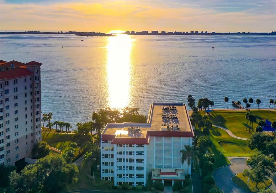 This exceptional penthouse end-unit offers elevated panoramic views of Sarasota Bay and the beautifully illuminated Ringling Bridge. As the largest floor plan available in Bay’s Bluff, the residence spans the entire width of the building and, with its expansive windows, offers either sunrise or sunset views from every room - - - and wonderful cross breezes! * * * 
Completely updated and meticulously maintained, this unit is move-in ready with furniture included.  Hurricane-impact windows and sliding glass doors provide added peace of mind. The screened lanai is situated so that it offers almost total privacy making it the perfect place to sit, relax and watch the seabirds, sailboats, and breathtaking sunsets.  The electric hurricane shutter even keeps the rain off the balcony during storms and will block the intense sun for the few minutes in the afternoon when the beautiful live oak tree doesn’t do that for you. * * *  
Bay’s Bluff is a charming, pet-friendly mid-rise community. The bayfront heated pool and grill area are ideal for hosting a sunset cocktail party or cookout. Or relax at the water’s edge in an Adirondack chair on the community’s 267-foot private seawall, where the soothing sounds of the bay will calm your mind and spirit. * * *  Location, location, location! Publix grocery is conveniently located just across the street; The Bay Park, Sarasota’s 53-acre cultural and waterfront destination, is only two blocks away; downtown Main Street is just one mile away, offering easy access to world-class dining, theaters, galleries and shopping; the Sarasota-Bradenton Airport is 4 miles away; and one of Sarasota’s many wonderful beaches lies just on the other side of the Ringling Bridge that you can see from the lanai. * * * Don’t miss this rare opportunity to own a premier bayfront residence in downtown Sarasota, with its sweeping water views, prime location, and exceptional value.