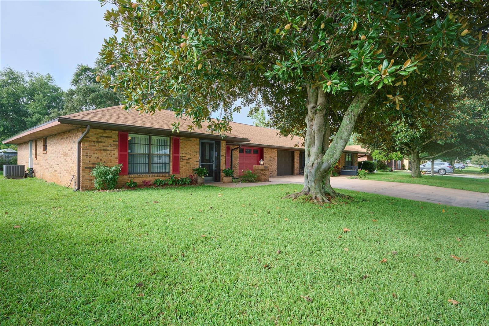 Nestled beneath a stunning magnolia tree in the front & a stately oak in the back, this freshly painted 2-bedroom, 2-bath duplex located in the Sun ’N Lake community offers both elegance & comfort. From the moment you step through the screened entrance, you'll appreciate the thoughtfully designed living spaces, complete with luxury vinyl plank flooring throughout. The well-designed layout seamlessly connects the living & dining areas, providing an open & airy feel while the color palette enhances the sense of space, allowing you to infuse your personal style into the home effortlessly. The living room boasts a cathedral ceiling with crown molding, recessed lighting, & a large industrial-style ceiling fan, creating a stylish yet cozy atmosphere. Adjacent to the living room is the dining area, with sliding doors that open to a spacious screened lanai, perfect for relaxing outdoors. Moving into the kitchen you find a tray ceiling with crown molding & crystal lighting adding a touch of sophistication. The galley-style kitchen is a chef’s delight with granite countertops, farmhouse sink, touchless faucet, & upgraded backsplash. This well-designed kitchen boasts an abundance of storage & counter space, including a large closet pantry equipped with electric for small appliances. Organize your provisions effortlessly, making meal preparation a joy in this conveniently designed space. A unique feature of the kitchen is the pass-through window to the lanai, creating a seamless connection between indoor & outdoor living. Imagine effortlessly passing refreshments or dishes to guests on the lanai while enjoying the fresh air & beautiful surroundings. This hospitable design element enhances the overall functionality of the kitchen & adds a touch of convenience to your entertaining endeavors. The master suite is a private retreat, boasting a generous layout with sliding doors leading to the lanai, an industrial-style ceiling fan, & a generous walk-in closet with built-in shelving. The ensuite bathroom features marble countertops, LED-illuminated mirror, completely remodeled shower with a built-in shower bench, & a luxurious rain showerhead. The guest bedroom is equally spacious & offers large front windows where the natural light enhances the colors & textures of the interior, creating a soft, glowing ambiance that shifts with the time of day, lending a dynamic & welcoming energy to the room. A beautifully appointed guest bathroom includes stone countertops, a vessel sink, & a tub/shower combo. Step outside where the lush landscaping provides a serene backdrop, creating an ideal space for small outdoor gatherings, gardening, or simply enjoying a cup of coffee. Benefits of this delightful home include a freshly painted interior, high ceilings, ceiling fans, irrigation, walk-in closet, single car garage, & a new roof in July 2022! Located in the Sun ‘N Lake Improvement District you will enjoy amenities such as community security, enhanced road maintenance, well-maintained dog park, community center, shuffleboard & pickleball courts, & they recently created a disc/frisbee golf course! Don’t miss this opportunity to own this charming home located near shopping, restaurants, & medical facilities! This duplex is a true gem, combining modern upgrades with charming outdoor spaces for the ultimate in Florida living! Don’t miss out on this opportunity to make it your own!