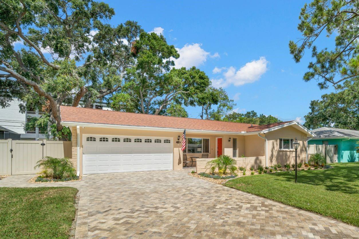 Experience modern living in this beautifully remodeled, unfurnished 3BR/2BA smart home—formerly a 5-star Airbnb—on a quiet, tree-lined cul-de-sac in sought-after Riviera Bay, just steps from shops and dining. Enjoy 1,400 sq. ft. of open, sunlit spaces with a designer kitchen (quartz countertops), upgraded appliances, lovely porcelain flooring, energy-efficient windows, and advanced smart home features: an amazing 5.1 home theater sound system, lighting, smart locks, switches, security cameras, and secure Wi-Fi router—all app-controlled for comfort and convenience. The beautiful porcelain-floored and spacious Florida Room with sliding vinyl windows offers extra living space most of the year, plus there’s a separate bonus room for office or hobbies. Outdoors, relax or entertain in a fully fenced backyard with lush landscaping, ambient lighting, outdoor speakers, paver patio, driveway, and walkways—ideal for pets and gatherings. A reclaimed water sprinkler system keeps the yard green, and a security system provides instant local alerts, with optional central monitoring via landline. One-car epoxy garage with storage and insulated door. $3,500 per month for 12 months, includes lawn care, landscape maintenance, and pest control. Tenant pays utilities. $50 non-refundable app fee per adult. Non-smokers, excellent credit only.