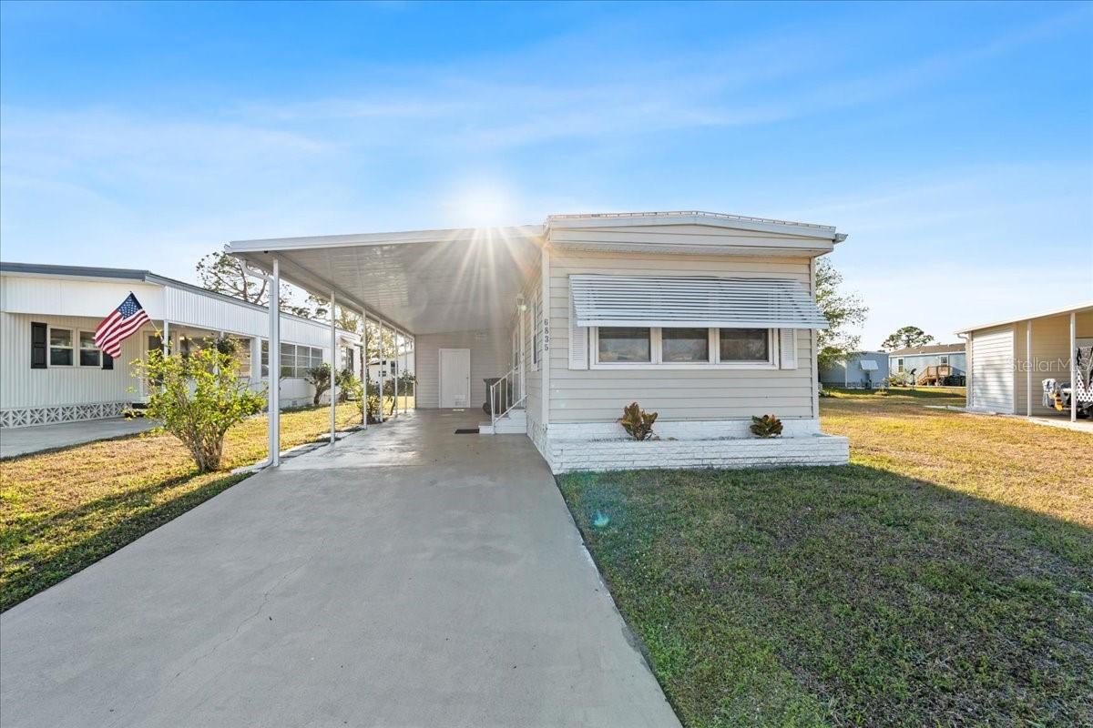 Welcome to your new home nestled in the vibrant and friendly 55+ community of Holiday Park. This 2-bedroom, 1-bathroom home features and NEW roof and beautiful LVP flooring throughout, offering a sleek, modern feel. The open-concept living, kitchen, and dining area provides an inviting atmosphere, perfect for entertaining or relaxing. The kitchen has been thoughtfully updated with stylish modern accents, and brand NEW appliances, making it both functional and visually appealing. Additional perks include a convenient storage/utility room, a long driveway with a carport for parking, and a well-maintained exterior. Whether you're looking for a seasonal retreat or a permanent residence, this home offers comfort and ease. Holiday Park provides unbeatable amenities, ensuring there's always something fun to do. The community boasts multiple Shuffleboard Courts, Horseshoe Pits, Pickleball Courts, Tennis Courts, Bocce Courts, and Ping Pong Tables. Two heated pools offer year-round enjoyment, while the Laundry Facility, Billiard Room, Fitness Center, and Card Rooms cater to your recreational and fitness needs. You'll also love the on-site Library, Ceramic Building with Kiln, and Dart Room. With weekly activities and events, there’s never a dull moment! This home's location offers access to every convenience! Enjoy nearby shopping, dining, and entertainment, as well as the beautiful beaches and nature parks of Southwest Florida. Come see why Holiday Park is the perfect place to enjoy your next chapter in life!