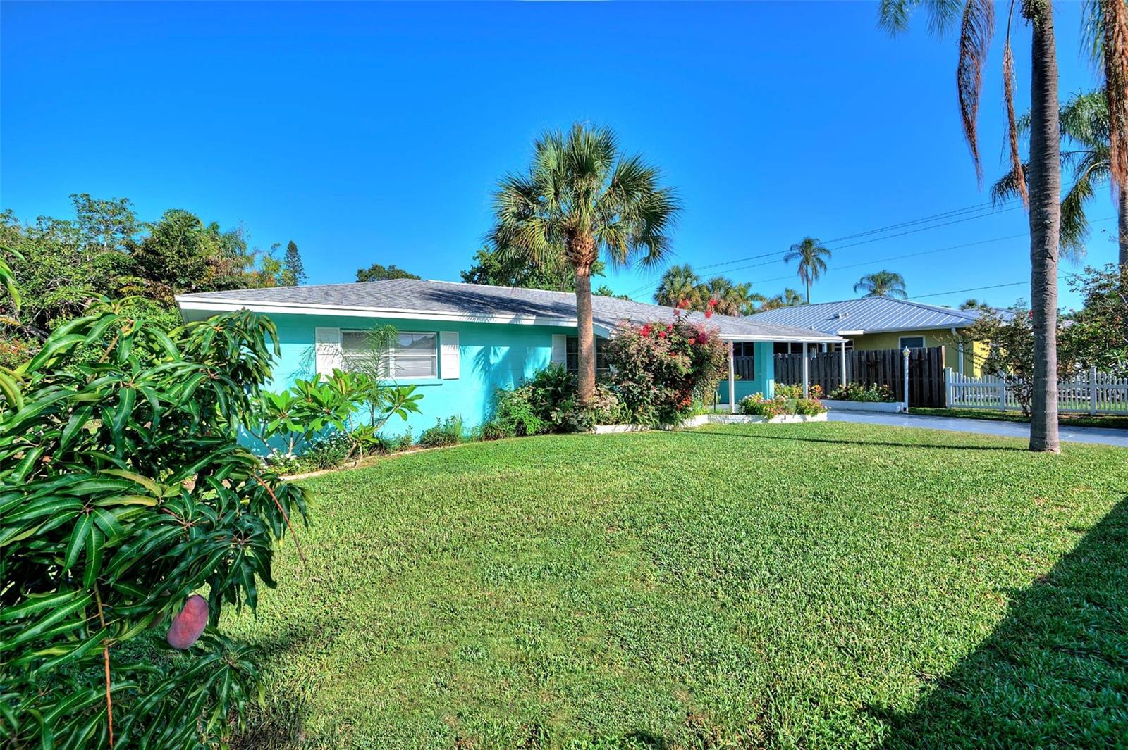 Available Now. Two bedrooms plus sunroom that could be used as third bedroom, and two full baths, with all utilities (water, yard service, pest control, alarm system, cable, high speed wifi, water and base electric) included in rent less an allocation for electric use. West of U.S. 41 in historic Indian Beach Sapphire Shores. Fenced and privacy-gated with lush front and back yards ideal for pets, vintage terrazzo flooring, 2023 roof and impact windows throughout. This classic and charming old Florida 1950s property is on a quiet dead-end street, short distance to Sarasota Jungle Gardens, shopping and two bayfront parks, and minutes to Ringling, Sapphire Shores Park, New College, SRQ Airport, USF, downtown Sarasota and area beaches. The primary bedroom and second bedroom have spacious closets and share a full bath with tub-shower combo. The sunroom with separate entrance features barn doors for privacy and can be used as either additional living space or a third bedroom with queen sleeper sofa and futon. The sunroom also features an armoire and clothes rack in the laundry room for extra closet space. The full second bath has a large tiled walk-in shower. The kitchen is fully equipped for cooking with all appliances and dishwasher, and the home also has a laundry/utility room with full-size washer and dryer, and bonus outdoor clothesline for drying. Efficient tankless water heater and plumbing have been redone. Outdoors, relax in the Florida sunshine where there is plenty of seating on the two tropically landscaped patios. Carport, driveway and street parking available, and one small boat is allowed with approval. A rented studio apartment is also on the property so the rear yard space may be shared at times. Pet friendly – two dogs allowed with approval. Non-smoking. Tenant pays $180 per month November – April for electric and water, and $250 per month May- October. All other utilities are included in rent ($450 value). Seasonal rent December – April $4,500 per month with a three-month minimum. Can accommodate a monthly to annual lease. A 13% tax on rentals less than six months.