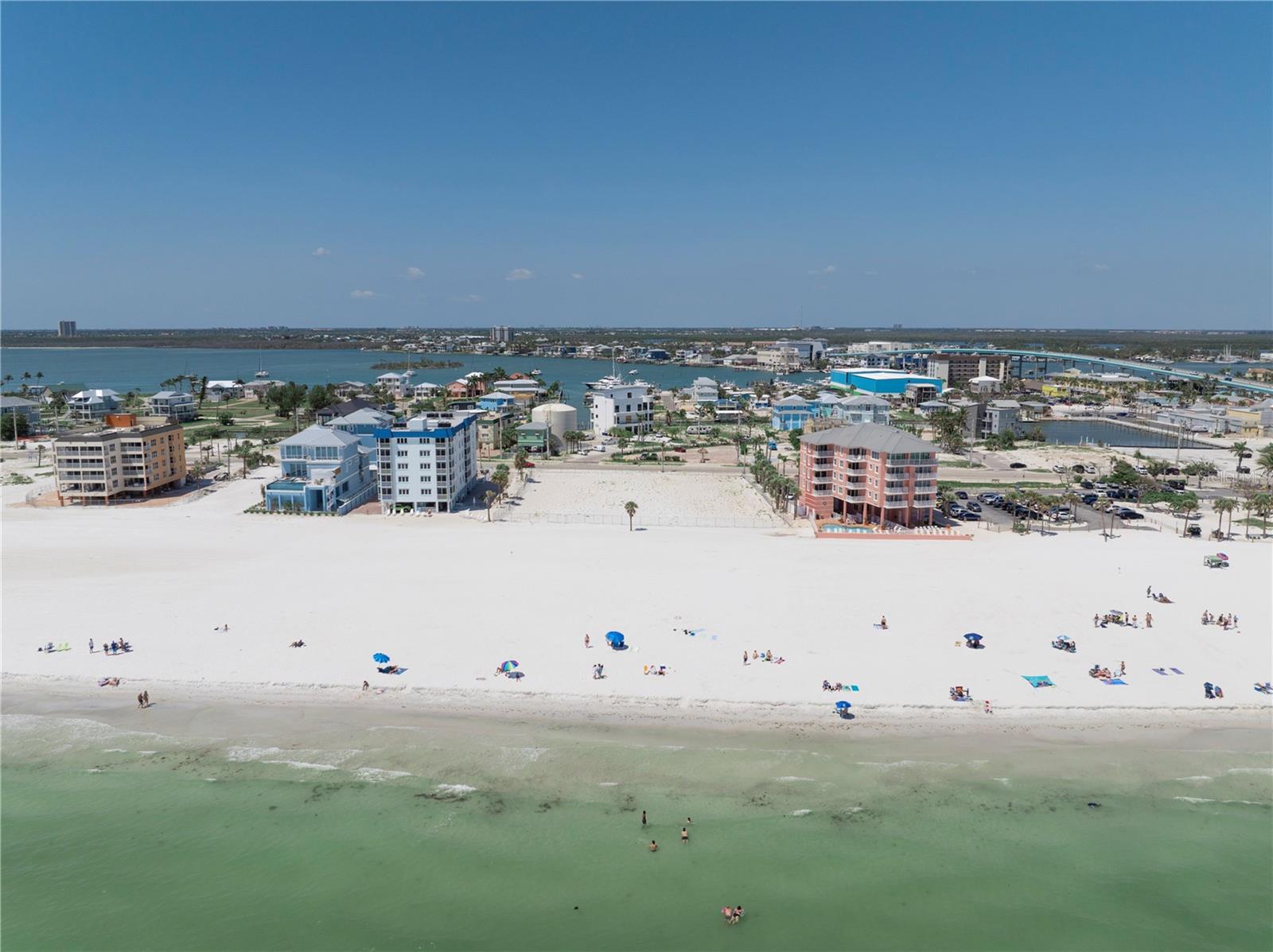 Positioned on approximately 1.72 acres of immaculate white-sand beachfront, this premier parcel offers nearly 220 feet of direct Gulf of Mexico frontage — a rare and coveted opportunity on Fort Myers Beach. With unobstructed, walk-out access to the shoreline, the site presents an ideal canvas for an exclusive high-end development such as a luxury condominium, boutique resort, or mixed-use commercial venture.
Strategically located just 0.4 miles from the newly opened Margaritaville Beach Resort and only 0.2 miles from the vibrant Times Square district and the iconic Fort Myers Beach Pier (currently undergoing a full city-led redevelopment), this property sits at the heart of Estero Island’s transformation. The surrounding area is poised for a wave of upscale dining, shopping, and entertainment venues — all of which will elevate long-term value.
Zoned for multifamily residential, tourist, and mixed-use development (pending confirmation), this Gulf-front site offers substantial flexibility and investment potential. With strong demand for luxury inventory, both for primary residences and short-term vacation rentals, the property is uniquely positioned to deliver exceptional ROI.
Easily accessible via Southwest Florida International Airport (RSW), this location appeals to both year-round residents and seasonal visitors seeking a private coastal enclave within walking distance to Fort Myers Beach’s most desirable attractions. As new development inventory remains limited, this is a truly rare opportunity to define the next chapter of refined beachfront living.