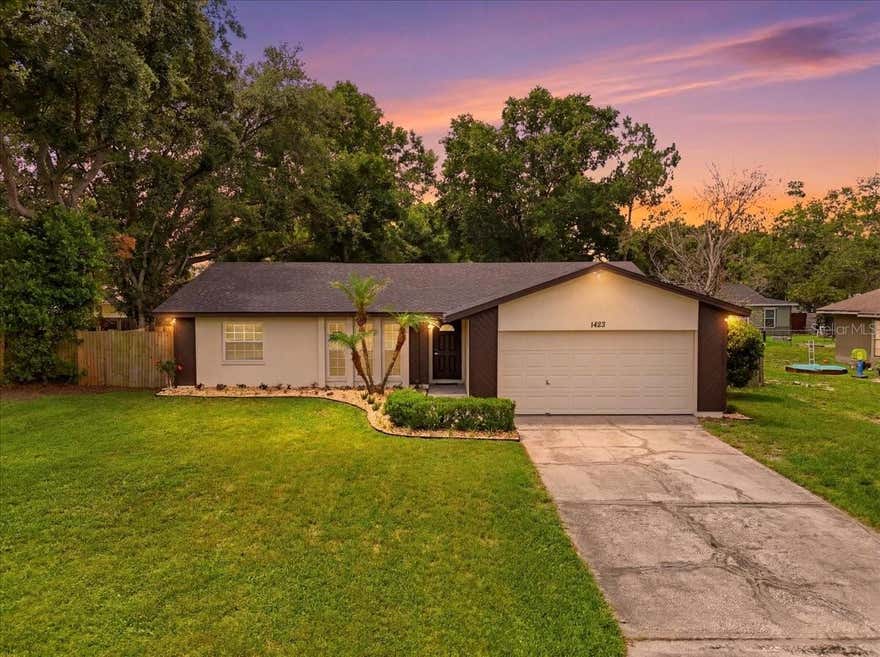 Welcome home to this beautifully updated 3-bedroom, 2-bath residence in desirable South Lakeland! Lovingly remodeled and move-in ready, this home offers a bright, open feel with gleaming wood-look laminate flooring throughout much of the home, abundant natural light, and tasteful designer-neutral colors that create a warm and inviting atmosphere.

The spacious living and dining room combination features large windows that fill the space with sunshine, while the beautifully appointed kitchen offers shaker cabinetry, granite countertops, stainless steel appliances, a breakfast bar, and a convenient closet pantry. French doors from the dining area lead to an expansive enclosed Florida room, providing the perfect setting for relaxing, entertaining, or enjoying year-round Florida living.

The desirable split-bedroom floor plan provides privacy and functionality. The spacious primary suite features a walk-in closet and a private en-suite bath with granite countertops. On the opposite side of the home, you'll find two comfortable guest bedrooms with built-in closets and wood-look laminate flooring, along with a well-appointed hall bath featuring tile flooring and a vanity with ample storage.

Recent updates include a new roof (2022), new HVAC system (2024), updated lighting, fresh interior paint, and newer windows, offering both style and peace of mind.

Step outside to enjoy the large fenced backyard and open patio, perfect for gatherings, pets, gardening, or simply enjoying the outdoors. The oversized enclosed Florida room is flooded with natural light and provides flexible living space for a family room, game room, home office, or entertaining area.

Additional features include a two-car garage and a fantastic location directly across from the community playground and basketball courts. With its thoughtful updates, inviting living spaces, and prime South Lakeland location, this home is ready to welcome its next owners. Don't miss this opportunity!