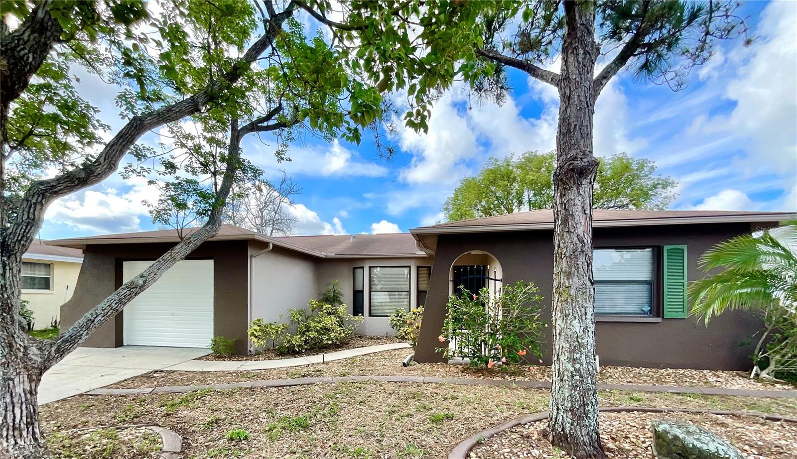 THIS BEAUTIFULLY REMODELED HOME IS SPACIOUS WITH 3 BEDROOMS 2 BATHS - SO CLEAN AND ON A NICE LOOKING STREET. OVER 1400 SQFT PLUS IT HAS AN UPDATED KITCHEN WITH NEWER CABINETS, GRANITE COUNTERS WITH BREAKFAST BAR AND STAINLESS STEEL APPLIANCES. ATTRACTIVE WOOD LAMINATE FLOORS THRU MOST OF THE HOME AND BEDROOMS. ENJOY HIGH CEILINGS, EXTRA LARGE GARAGE AND WASHER / DRYER. BONUSES ARE FENCED TREE SHADED YARD WITH SPRINKLERS ON WELL TO SAVE YOU $$ AND ENCLOSED REAR LANAI WITH REMOVABLE VINYL WINDOWS. BEDROOMS 2 AND 3 ARE BIGGER THAN MOST AND BOTH BATHS ARE ROOMY AND CLEAN . THIS HOME HAS MANY FEATURES FOUND IN MUCH HIGHER PRICED HOMES - ITS READY TO VIEW AND WAITING FOR YOU. GOOD CREDIT + BACKGROUND ALONG WITH SUFFICIENT INCOME REQUIRED. Ready SEPT 1 2025 CAN BE VIEWED PRIOR. NO PET FEES BUT ONLY SMALL NON AGGRESSIVE BREEDS.