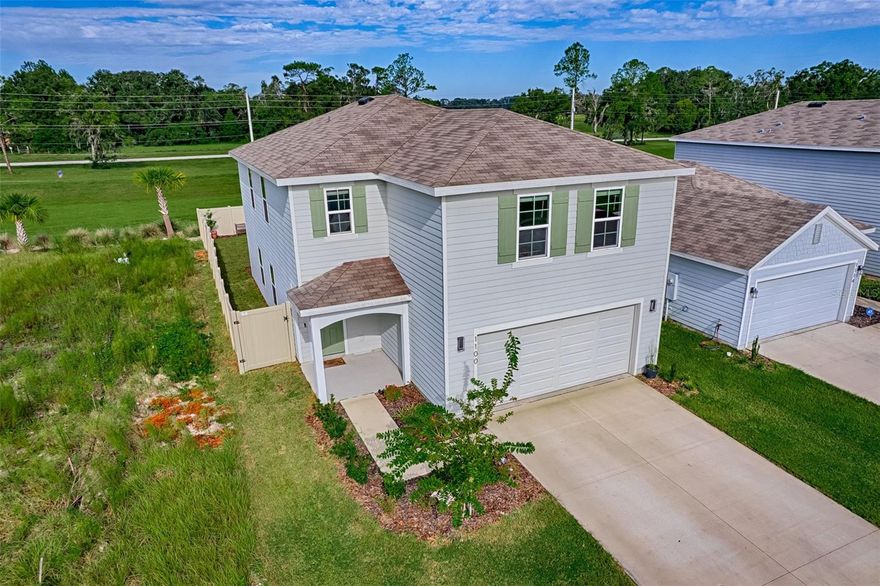 This spacious 4-bedroom, 2.5-bath home sits on one of the most scenic lots in the desirable Avalon Woods neighborhood in Newberry. Built in 2024, this two-story SMART home offers modern design, comfort, and beautiful natural surroundings. The open-concept kitchen features quartz countertops, wood shaker cabinets, and an oversized island perfect for entertaining, all overlooking a bright great room that easily accommodates comfortable living and gathering spaces. Step outside through sliding glass doors to a private patio and fenced yard with stunning, unobstructed views of century oak trees, rolling pastures, and breathtaking cotton-candy sunsets. Upstairs, the primary suite offers a spacious walk-in closet, dual vanity, and walk-in shower, creating a relaxing retreat. Three additional bedrooms provide ample space for family or guests, along with a versatile landing area ideal for studying, reading, or gaming. Additional highlights include smart home features (thermostat, doorbell, backyard camera, and lighting options), stainless steel appliances, and major systems all under two years old including HVAC and water heater. Storage is abundant with a walk-in pantry, multiple oversized closets, a double-gated fenced yard, and a two-car garage. Conveniently located only minutes on foot to the Easton Sports and Archery Complex and just minutes from top-rated schools, a new Publix, shopping, and dining. Easy access to UF Health, HCA, and VA hospitals makes commuting simple. Enjoy the charm, community, and lifestyle that Newberry, FL has to enjoy.