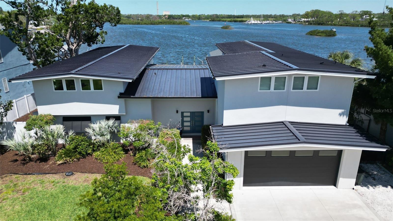 One or more photo(s) has been virtually staged. Riverside elegance meets Gulf-coast adventure
Set on the sparkling Anclote River with unobstructed, bridge-free passage to the Gulf, this re-imagined Tarpon Springs estate delivers more than 5,000?sq?ft of resort-style living and entertaining.
Inside highlights
Magazine-worthy great room – soaring ceilings and a 10-ft wall of impact sliders frame panoramic water views.
2019 whole-home renovation – added a 1,122?sq?ft primary wing, opened the floor plan, upgraded to a new roof and full-house impact glass.
Chef’s dream kitchen – quartz counters, oversized island, Wolf gas range & double ovens, Sub-Zero refrigeration, pot-filler, wet bar, walk-in pantry and sunny breakfast nook.
Primary retreat – a private wing with balcony, wet bar, custom dressing room with granite island, Sunlight?M-Pulse infrared sauna, and a spa bath (dual vanities, free-standing tub, multi-head rain shower).
Family wing – three generous bedrooms: two share a stylish bath; one enjoys its own ensuite and pool/river views.
Wide-plank luxury vinyl flows throughout for worry-free style.
Extras that matter
Oversized tandem garage with Tesla charger.
Driveway parking (with RV hook-up) plus room for a boat trailer.
Newer roof, impact windows/doors, and whole-home mechanical upgrades.
Outdoor oasis
2019 outdoor kitchen: granite bar, Twin?Eagles grill, beverage coolers, sink, seating for a crowd.
Heated salt-water pool with sunshelf and spa overlooking the river.
Two docks: a fixed fishing/launch dock and a floating dock for effortless boarding.
Covered boathouse with lift plus a permitted in-law suite (kitchen, living, bedroom, bath) freshly remediated and ready for your vision—guest cottage, tiki bar, or river lounge.
Peace of mind
The main residence stood high and dry through the 2024 storms; only the boathouse required remediation.
Why you’ll love it
Waterfront grandeur, Gulf access in minutes, room for every toy, and a layout built for memorable gatherings—all on an oversized riverfront parcel.
Schedule your private tour today and start living the Anclote River dream!