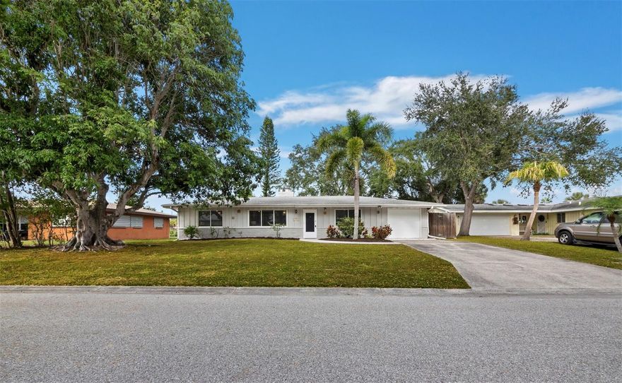 Don’t miss this adorable South Gate gem!  The location could not be more convenient – walk to the Crossings at Siesta Key Mall and less than a mile to the north bridge to Siesta Key itself! For those with school-age children, the close proximity to Brookside Middle School and Southside Elementary zoning are great perks. Completely updated inside with an elegant kitchen (granite, pretty backsplash, stainless appliances), chic wood-look flooring throughout, a charming fireplace, and recently renovated baths, it is move-in ready! Ideally positioned for ultimate convenience to the many amenities of Sarasota, the home sits within Sarasota City Limits, which means weekly rentals are permitted, expanding the possibilities from a full-time or seasonal abode to a prime investment opportunity. The space inside is used really well, with nice spacious bedrooms and a split-bedroom plan, and outside you’ll enjoy a covered screened patio and HUGE fully fenced backyard! There is currently a fun fire pit and open land, so the large yard can be a blank canvas for your outdoor Florida dreams. There is plenty of space for a pool, if that is your desire, or maybe you prefer to plant an edible garden? The choice is yours and this lot can accommodate it all!  An oversized 1-car garage with separated extra storage space and laundry completes the package. Easy to show, schedule your visit today!