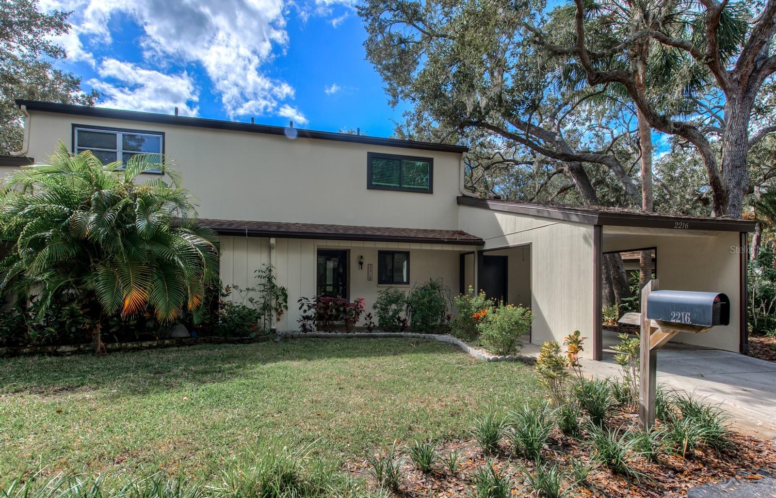 MOTIVATED SELLER! TAKE NOTE OF THIS NEW PRICE AND UNBELIEVABLE VALUE! DON'T MISS OUT ON THIS HIDDEN GEM JUST 9 MINUTES TO SIESTA KEY BEACH and within walking distance to Gulf Gate Village and all of its fun shops and restaurants. The huge open great room greets you as you step inside this updated townhouse condo. Easy care laminate floors lead you to the spacious Florida room overlooking the green spaces and stately oaks in the rear yard. HURRICANE IMPACT windows and new custom blinds have been installed throughout. Bead board ceilings and paint colors in calming hues complement the ambiance created by the natural views that surround the home. The chef of the family will be delighted with the updated kitchen featuring quartz countertops, loads of cabinet storage and the large window over the kitchen sink. The powder room off the foyer has been upgraded with a comfort height commode and pedestal sink. The enormous storage closet under the stairway gives you additional space as needed. The Florida room is a great flex space to be used as an office, studio or library and boasts views of the green spaces in the rear yard. The covered patio in the rear of the home is a lovely space to take in nature. The owners suite has a private balcony amongst the oak trees, a large walk-in closet and an en suite bath. The primary bath has a roomy walk-in shower, dual sinks, an enormous amount of cabinet storage, quartz countertops, clerestory windows and a comfort height commode, every detail was thoughtfully planned out. Bedroom 2 also boasts an updated en suite bath with quartz countertop, designer vanity and sink, comfort height commode and a tub/shower combination. The carport gives you covered parking and the enormous laundry room off the carport gives you loads of additional storage space for your beach and pool toys. An additional storage closet off the front entryway gives you even more storage. NEWER A/C IN 2019 AND NEW ELECTRICAL PANEL IN 2023 give you added peace of mind. Mix and mingle with your friends and neighbors in the community pool or join the fun on the tennis and pickleball courts. Woodside Village East has access to the adjacent church and its shady walkways. The location can't be beat. Crystal sandy beaches, tranquil gulf waters, downtown Sarasota, fine dining, shopping and the art & cultural venues of Sarasota are all within minutes of your new home. Schedule your private showing today!