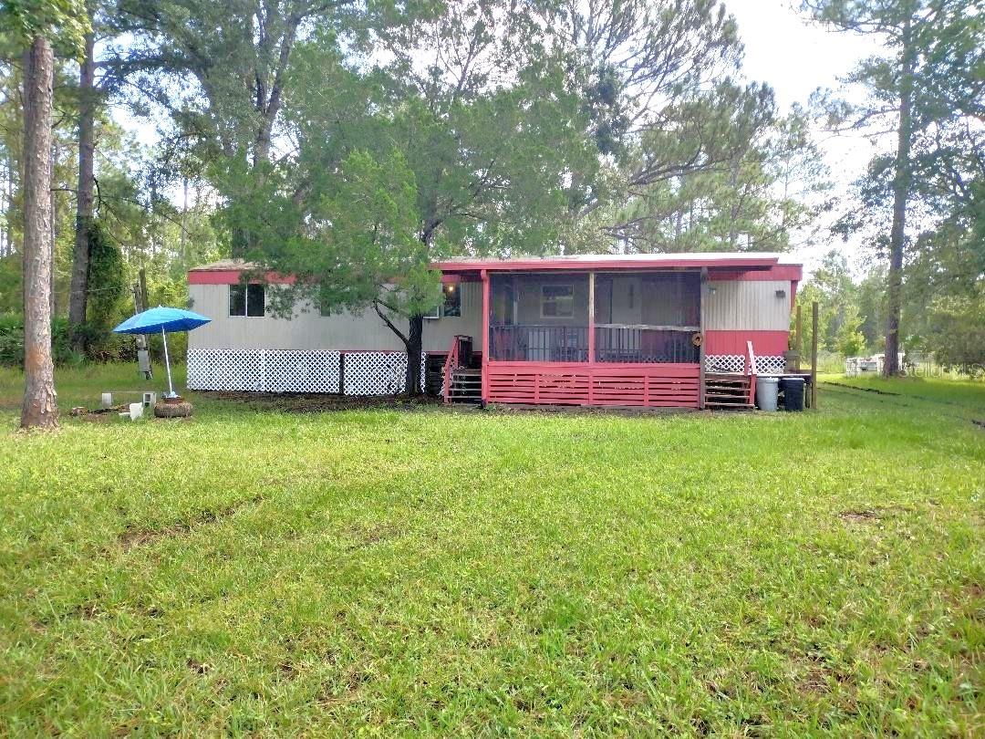 Affordable Country Living – 2 Bedroom, 2 Bath Singlewide with Fenced Yard & Screened Porch Welcome home to this well-kept 2 bedroom, 2 bath singlewide mobile home featuring a comfortable open floor plan and thoughtful updates throughout. Enjoy the inviting screened porch with entrances on two sides, perfect for morning coffee or evening relaxation. A handicap-accessible ramp makes entry easy and convenient for all. Inside, the home offers a bright kitchen with lots of windows, a breakfast bar, and open living and dining areas. The roomy bathrooms provide plenty of comfort, while the large master bedroom offers space to unwind. The corner grassy fenced yard is ideal for pets, gardening, or outdoor gatherings. A big, partly renovated shed adds excellent storage or workshop potential. This property is ready for its new owner—whether you’re downsizing, investing, or looking for your first home, it’s a great opportunity for affordable Florida living.