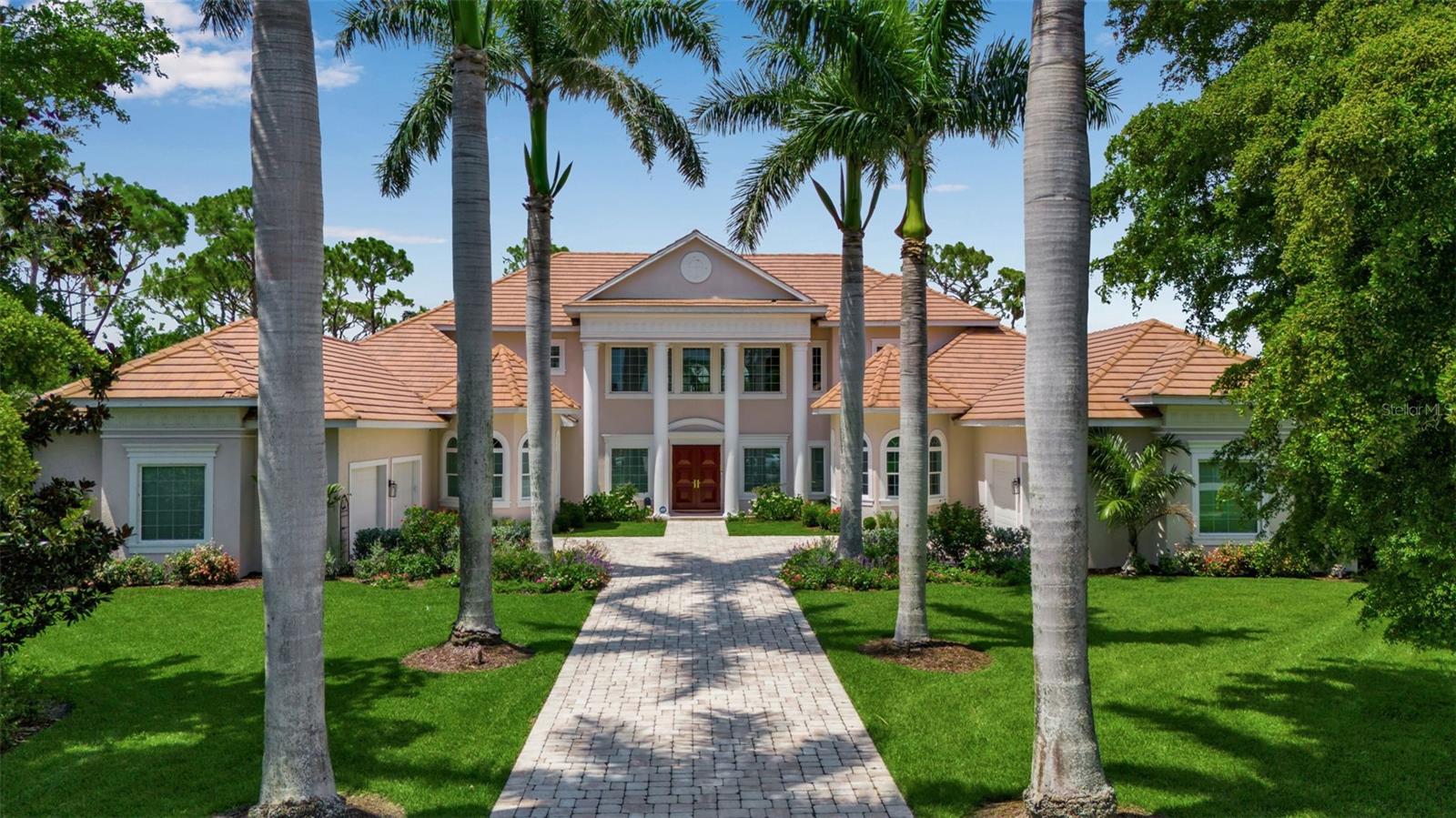Sited at the end of a quiet cul-de-sac behind the gates of the prestigious Oaks Clubside in Osprey, Florida, this stately traditional custom estate offers refined living in one of Sarasota County’s most exclusive communities. Perfectly positioned on over three-quarters of an acre, the residence boasts serene preserve and fairway views, capturing the essence of Florida luxury living. Inside, discover graciously sized rooms, soaring ceilings, and abundant natural light that fills every space. The formal living room with gas fireplace and the formal dining room provide elegant spaces for entertaining. The open-concept kitchen and family room are the heart of the home, ideal for casual gatherings and everyday comfort. A large kitchen offers a generous walk-in pantry, plentiful storage, and a seamless flow into the family room and outdoor spaces. The primary suite is located on the main floor, offering a tranquil retreat with a spa-like bathroom, separate dressing room, and expansive walk-in closet. An office with fireplace is also on the main level, perfect for work-from-home privacy. Upstairs, two additional bedrooms and a bonus room provide a private haven for guests or multi-generational living. Step outside to the screened and covered outdoor living area, where a summer kitchen, cabana with full bath, and lush landscaping invite indoor-outdoor living year-round. It’s an entertainer’s dream, ideal for both intimate gatherings and grand events. Key features include wind-rated impact windows, new tile roof to be installed with a transferable 20-year workmanship warranty, $800,000+ in updates under current ownership, and situated on an oversized lot with ultimate privacy. As part of The Oaks Club, enjoy world-class amenities including two championship golf courses, 12 Har-Tru tennis courts, pickleball, croquet, a state-of-the-art WellFit Center, and exceptional dining at The Oaks Room, The Overlook, and The Tavern. This is more than a home—it's a lifestyle. Experience the timeless elegance, thoughtful design, and unmatched amenities of The Oaks Club in this remarkable estate.